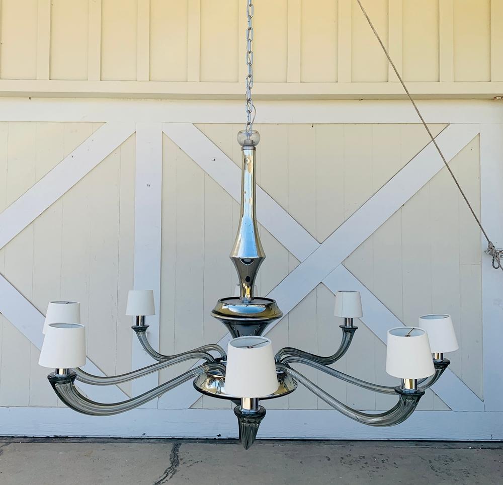 Beautiful chandelier created by Seguso for the Angelo Donghia showrooms.

The piece center pieces in the main structure have a mercury silverish tone and the arms are a in a gray color.

Each arm is 24 inches long and the complete diameter is 55