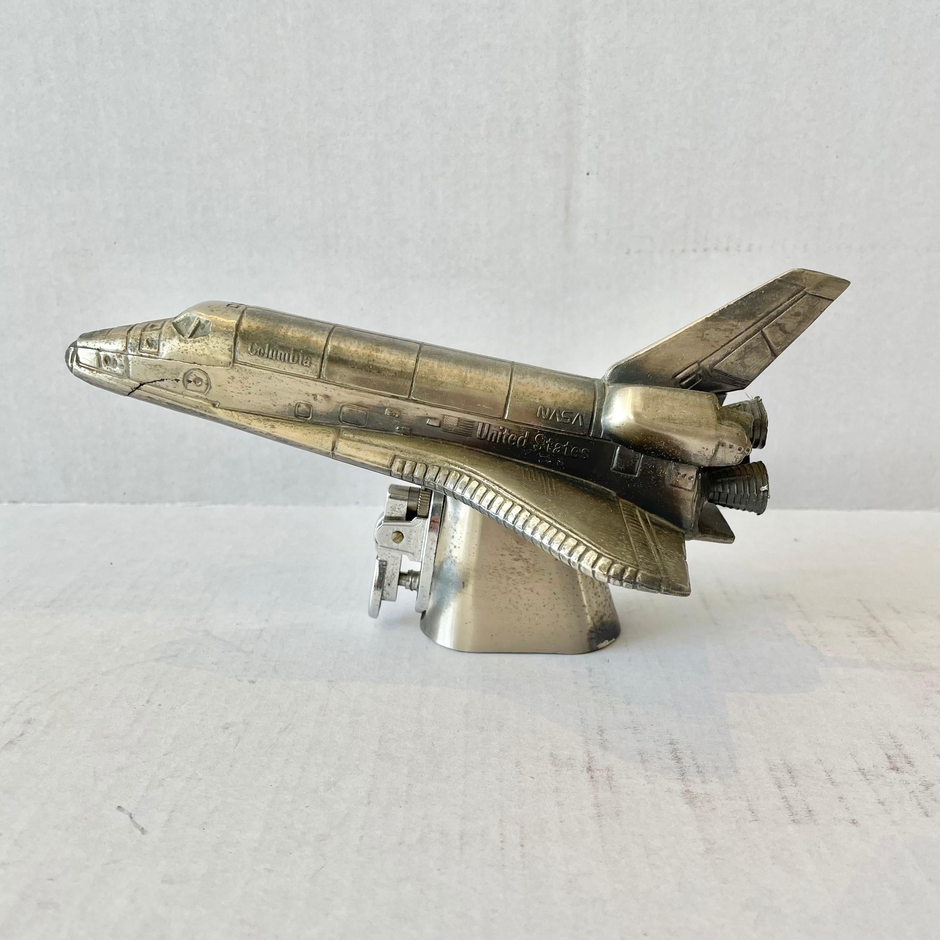 Cool vintage table lighter in the shape of a Nasa space shuttle. Made in Japan, 1980s. This piece has great balance and details. Cool tobacco accessory and conversation piece. Working lighter. Good vintage condition with crack on underside of nose.