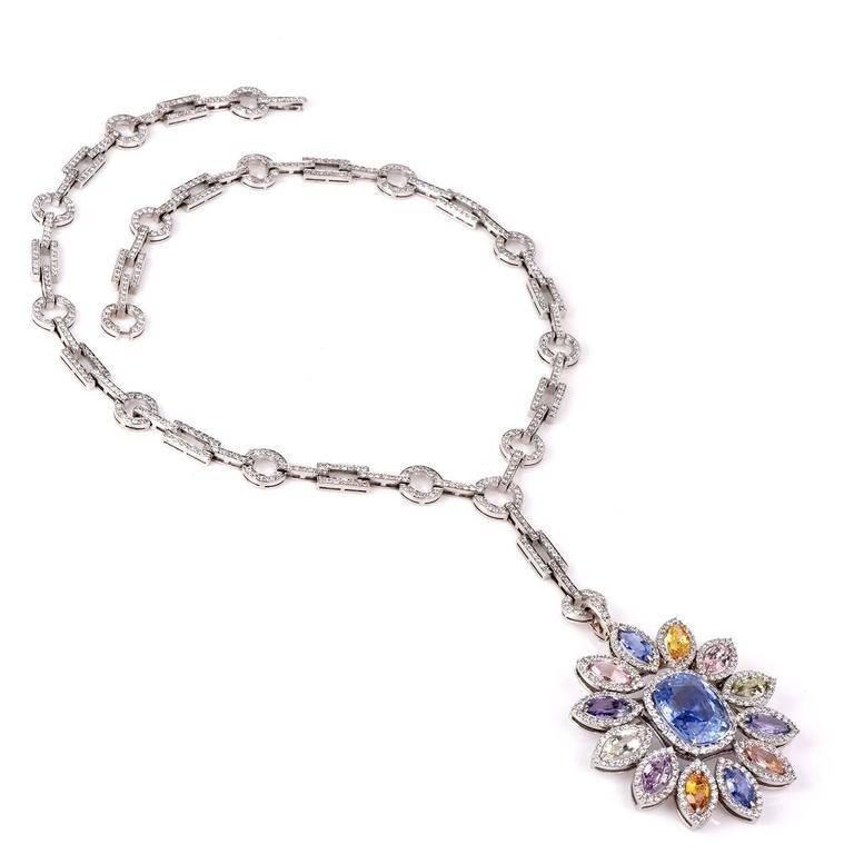 This graceful art deco design diamond necklace with vivacious multi-gem sapphires is hand crafted in solid 18k white gold. Weighing 88 grams and measuring over 18