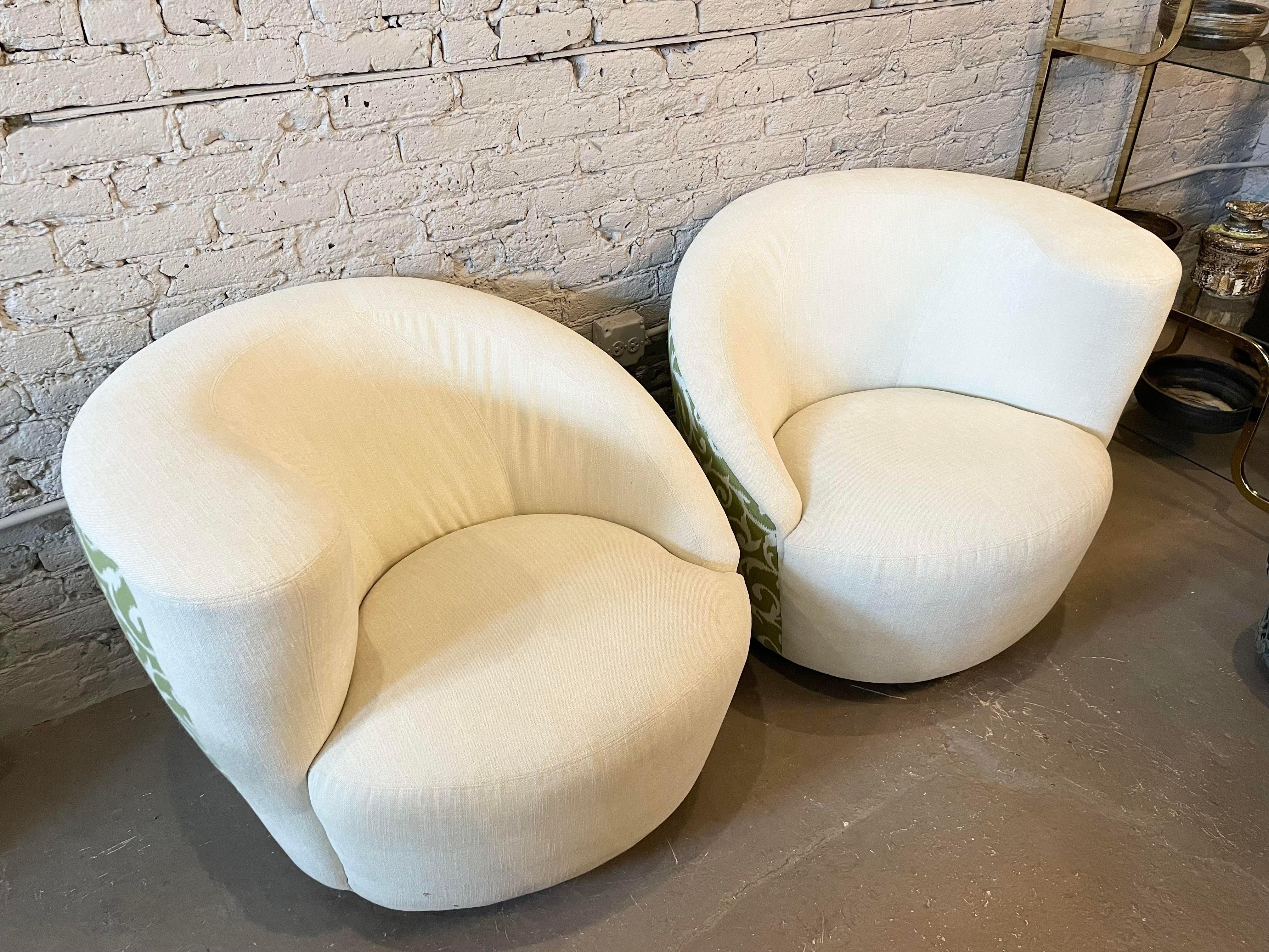 Beautiful pair of nautilus chairs with a green fabric on back. They rotate 180 degrees each direction. The original upholstery is in excellent condition and can be used as is or redo in your favorite fabric.