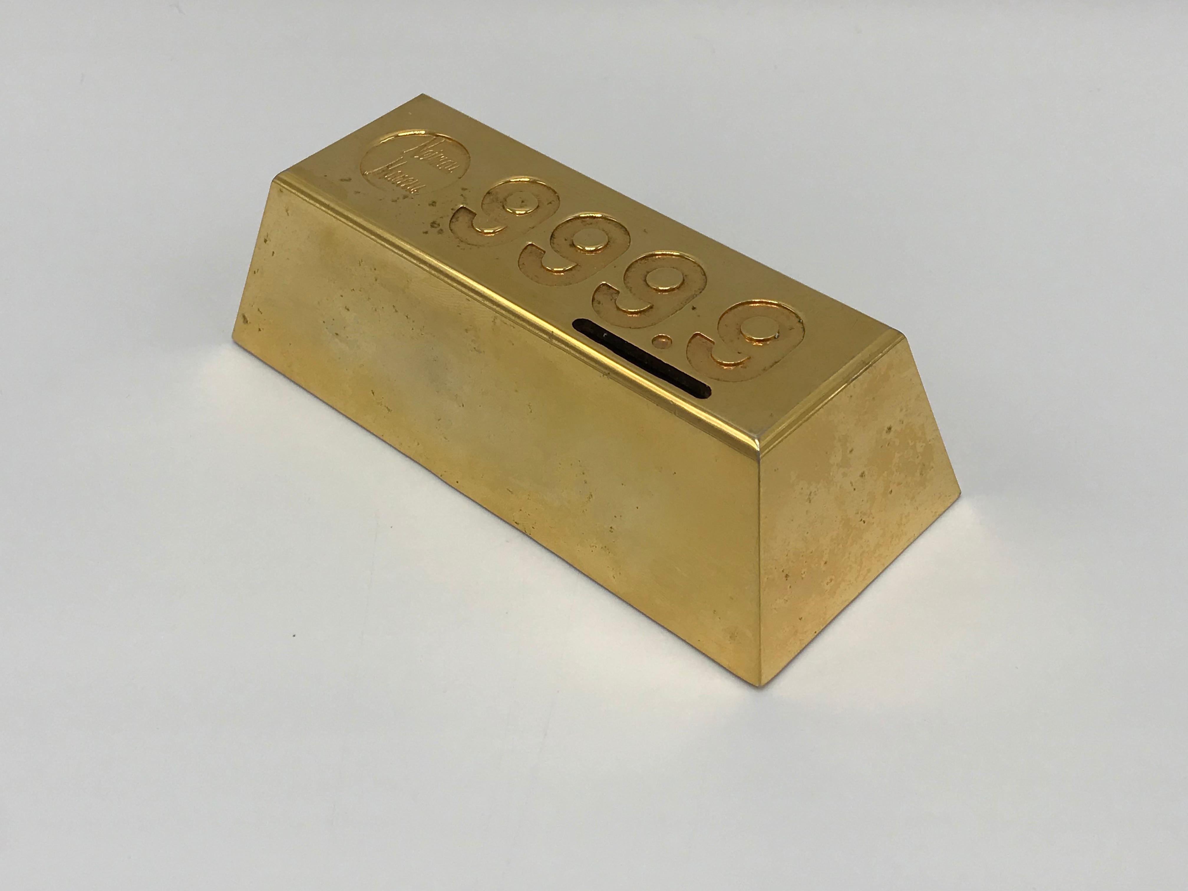 Offered is a highly covetable and collectable, 1980s Neiman Marcus gold-plated brick desktop spare-change bank. Truly a unique and rare collectors item! Marked 'Neiman Marcus' on top. Screw-off insert on underside to remove change. Heavy.