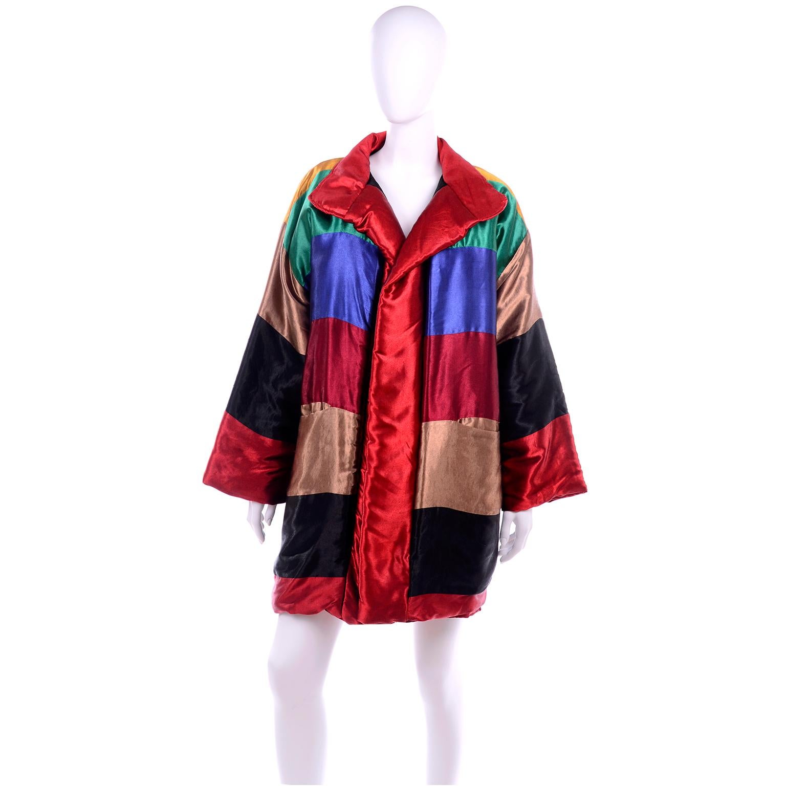This is a fabulous vintage reversible rayon rainbow coat from Neiman Marcus.  This open front , oversized coat has colorful stripes in green, yellow, blue, maroon, bronze and black on one side and black and red on the other side. The coat has