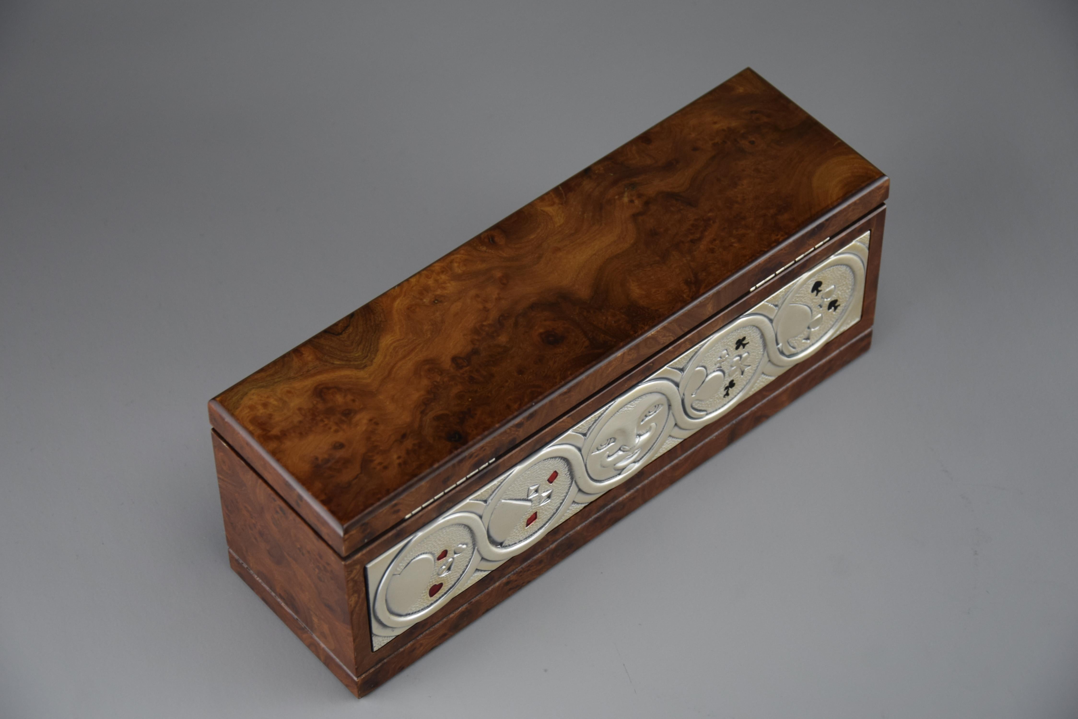 For collectors and poker enthusiasts, this pristine 1980s poker set designed by the renowned Studio Ottaviani is a rare find. Encased in luxurious burl walnut, this Italian-crafted masterpiece features exquisite silver and enamel inlays, showcasing
