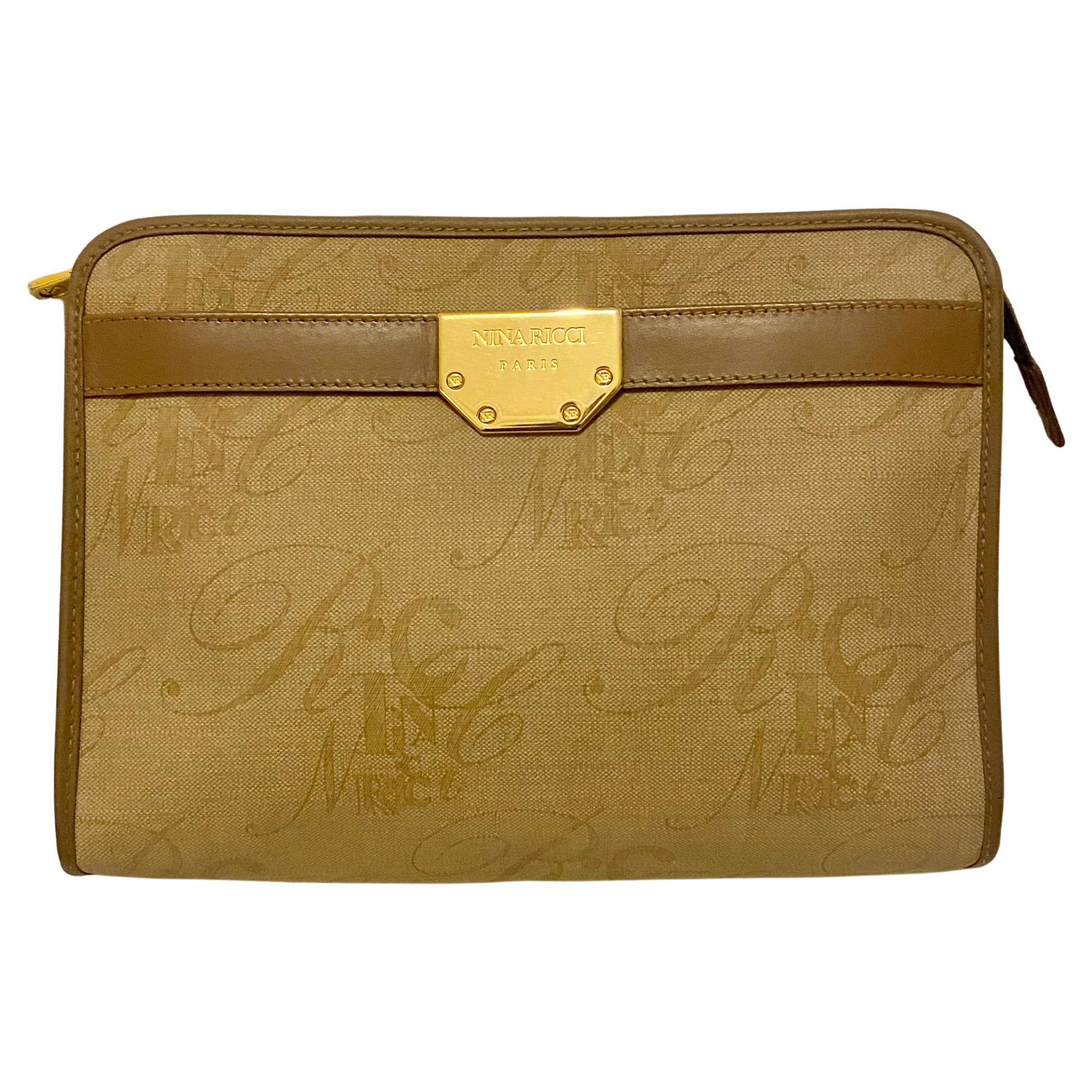 Vintage 1980s Nina Ricci clutch crafted from a combination of high-quality vinyl and leather, small Boston-style bag features a classic brown exterior color and gold-plated hardware., zip closure, gold tone metalware, front small sleeve pocket,