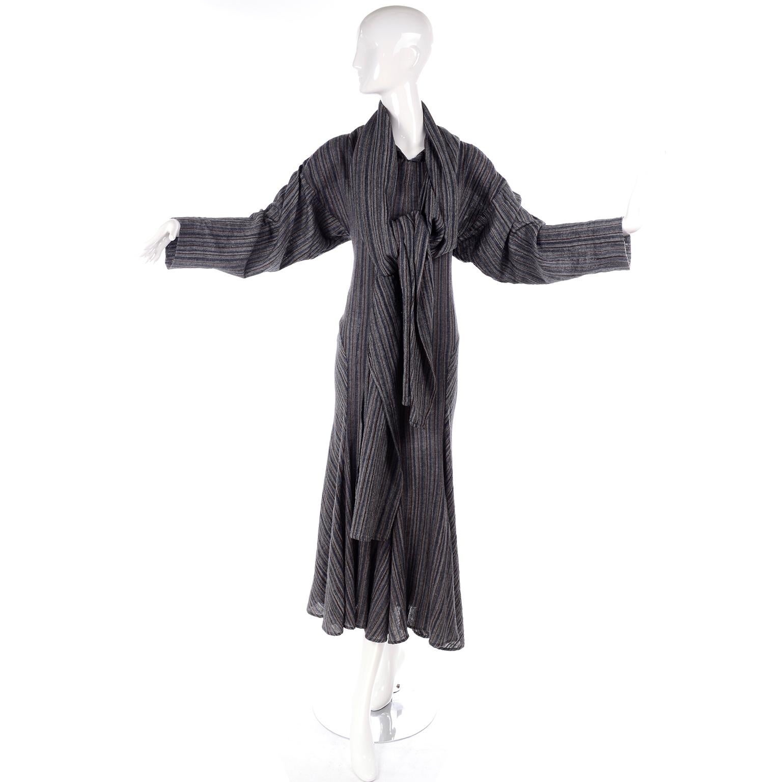 This is a fabulous vintage dress designed by Norma Kamali in the 1980's.  The dress is in a nice gauze like Gray fabric with red and navy blue stripes. This dress comes with a long scarf that can be worn in a number of ways, including as a hood, as