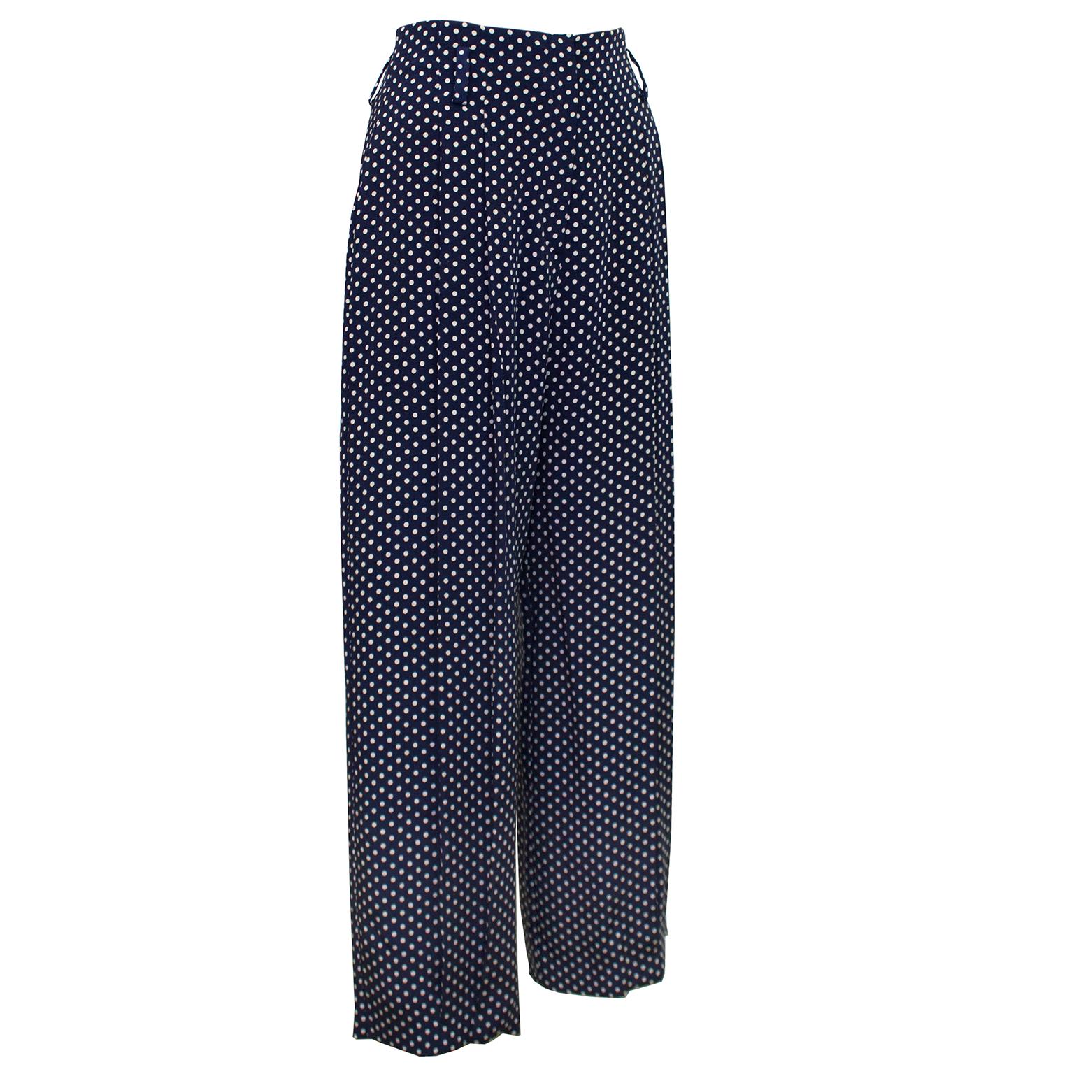 Norma Kamali trousers from the 1980s. Navy blue silk with all over small beige polk dots. High waisted with belt loops and centre front zipper closure with hook and eye. Wide leg with doubled pleated fronts. Unlined. 2