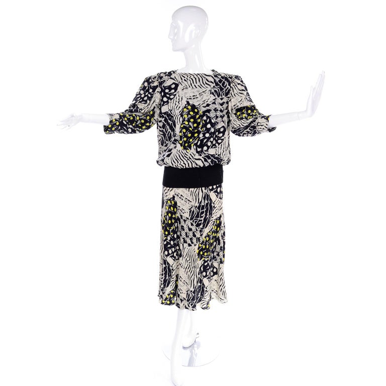 This is a 100% silk dress from designer Norma Walters. This 1980's vintage dress is in a black and white abstract print with yellow dots and has an oversized fit with shoulder pads, 3/4 length sleeves, and a ribbed knit drop waist panel.  The dress