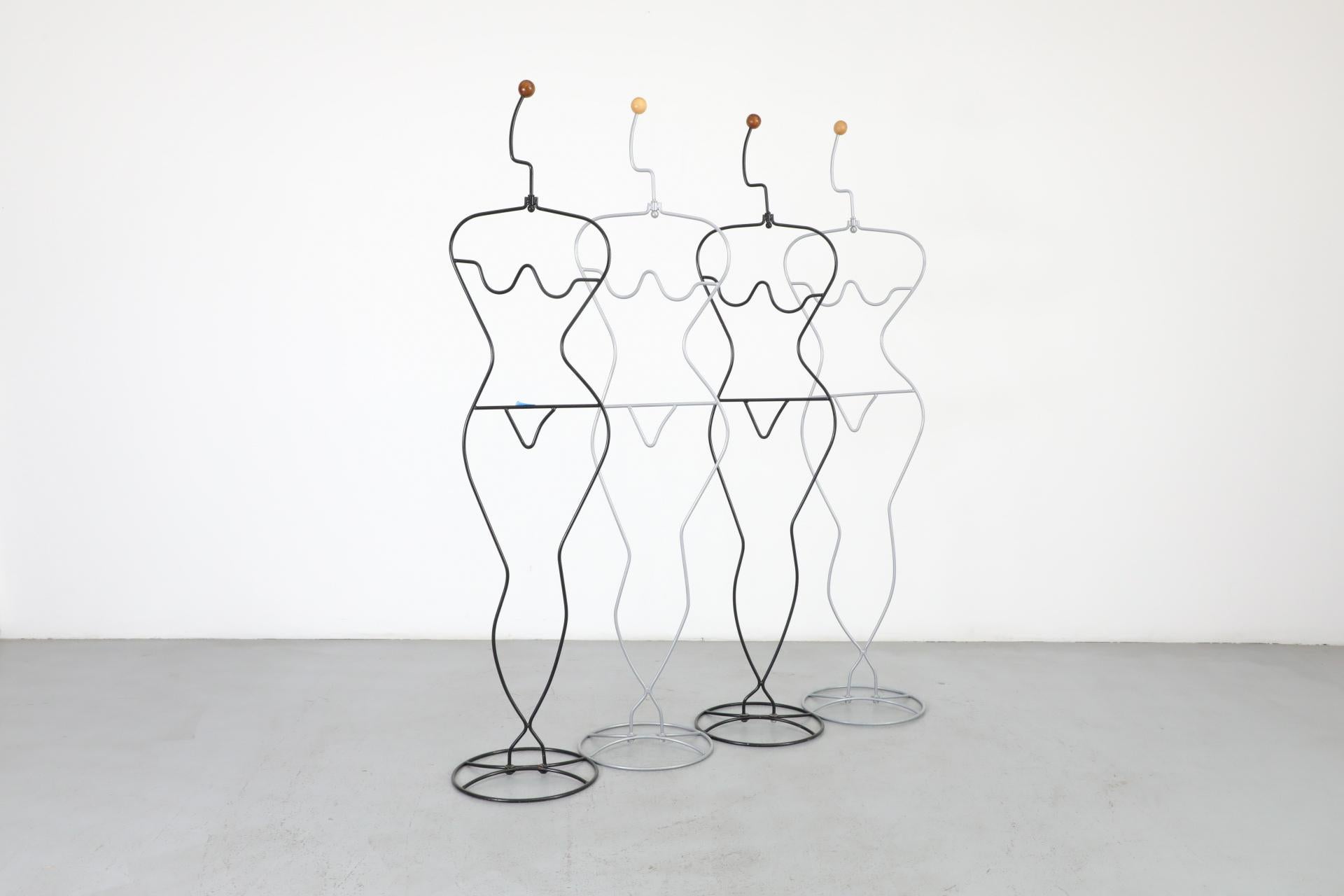 Ehlén Johansson Häpen valet - clothing stand made of silver enameled metal bent into a feminine form and topped with wooden ball. Eye-catching design that's as useful as it is appealing. Can be used traditionally to hang clothes on or as a fun home