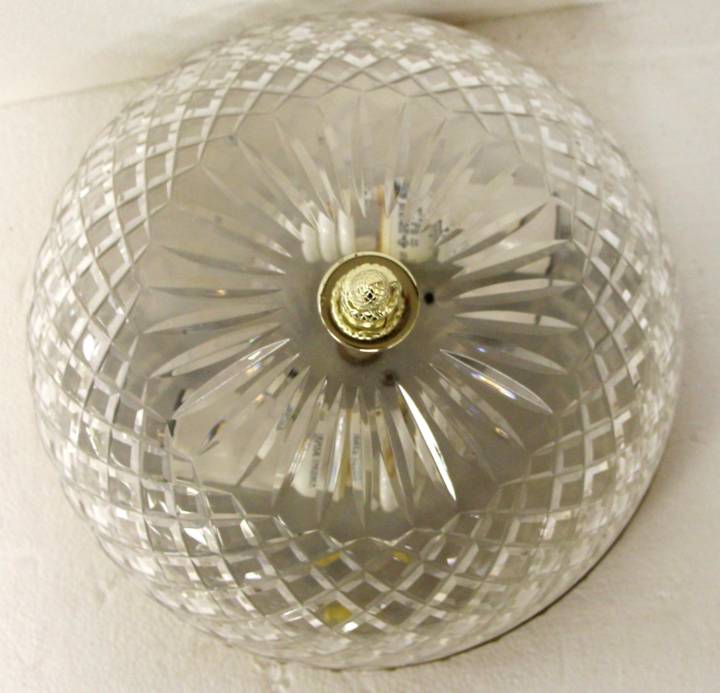 This large crystal flush mount light adorned many of the corridors of the NYC Waldorf Astoria Hotel. The shade is clear crystal and features a brass pineapple finial. A brass decorative rim completes the look. Waldorf Astoria authenticity card