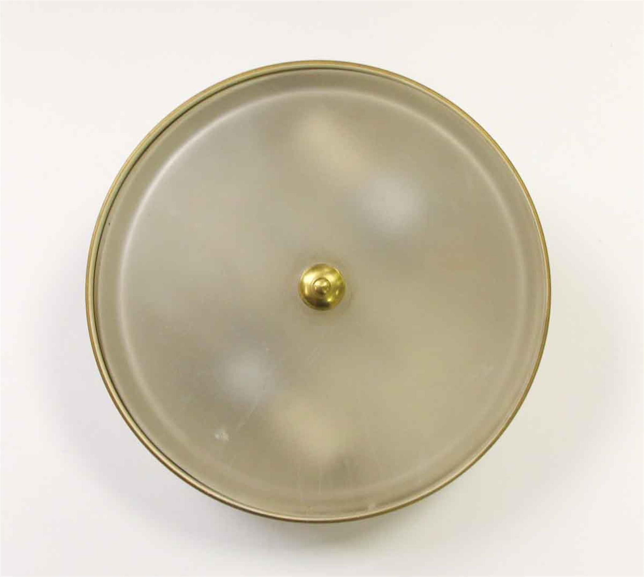From the 20th Century NYC Waldorf Astoria Hotel. Simple Mid-Century Modern pill box design flush mount light with frosted glass. This fixture is hand painted in a beige tone with gold gilt rim. A Waldorf Astoria authenticity card included with your