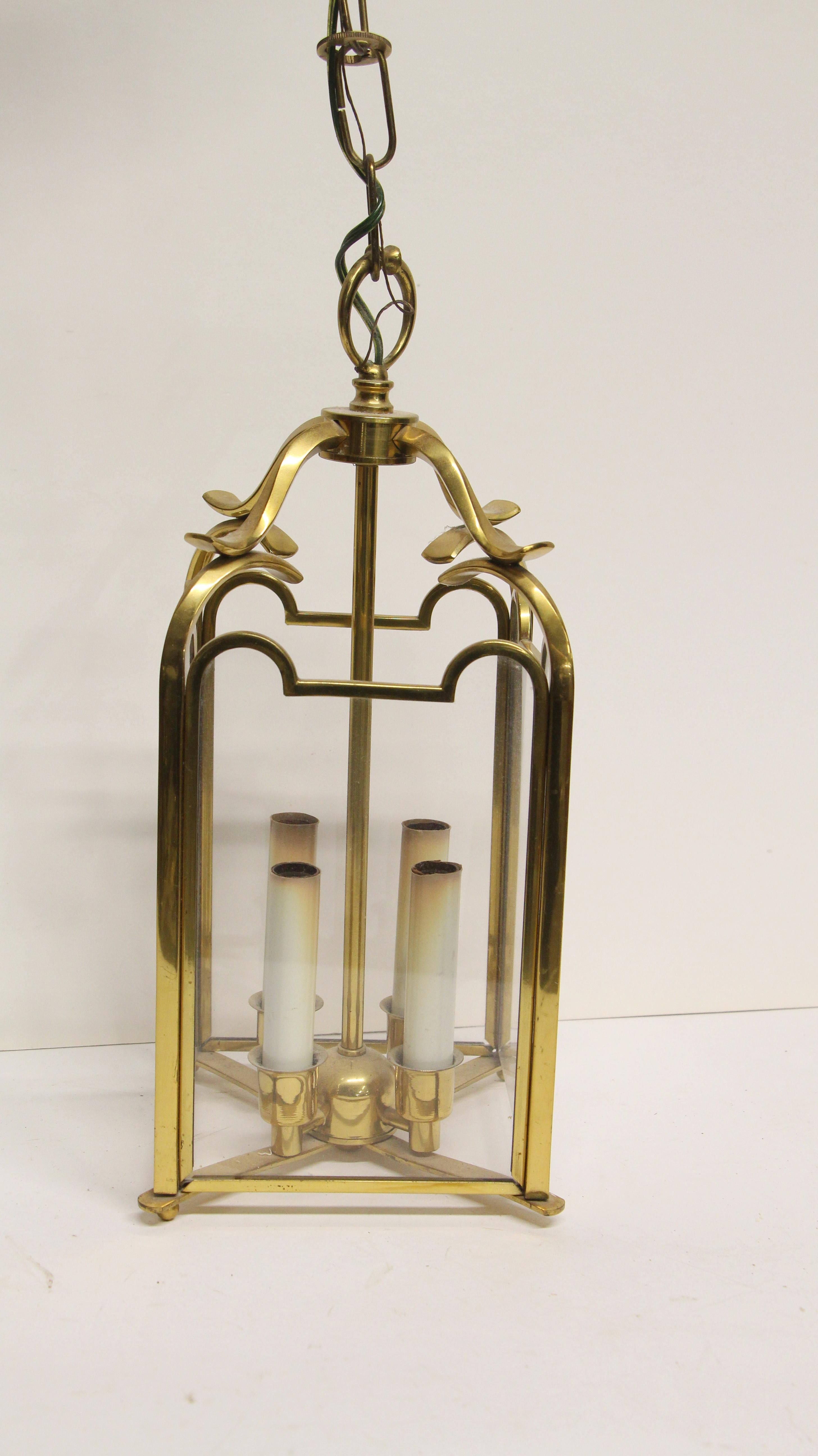 This is from the 1980s NYC Waldorf Astoria Hotel. Four-light glass and polished brass pendant lantern. Waldorf Astoria authenticity card included with your purchase. This can be seen at our 400 Gilligan St location in Scranton, PA.