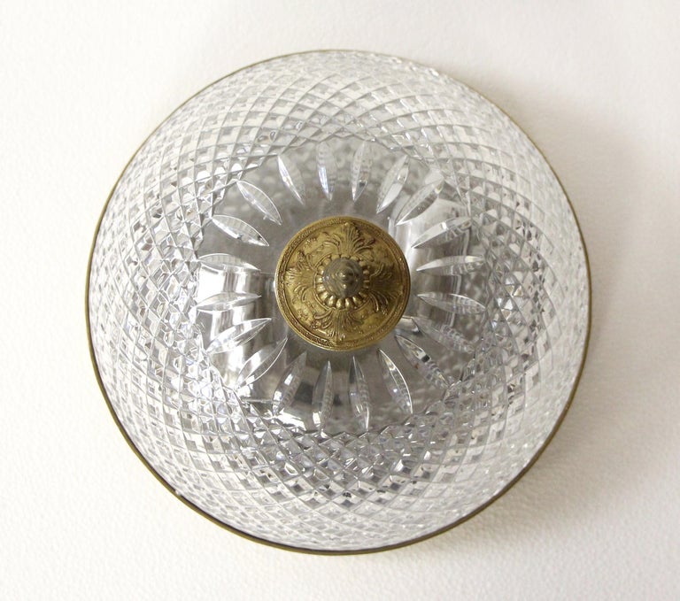 Clear crystal Italian flush mount light with a brass decorative rim and finial from the 1980s. Reclaimed from the corridors of the Towers of NYC Waldorf Astoria Hotel. A Waldorf Astoria authenticity card included with your purchase. Small quantity