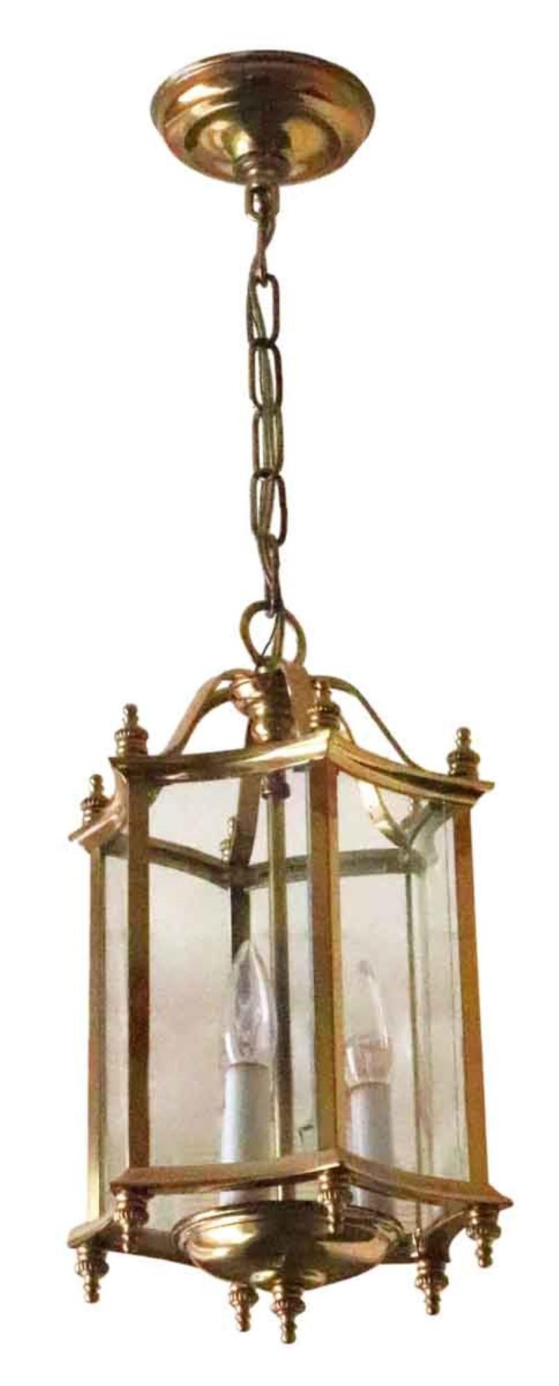 1980s brass frame hexagon lantern pendant light with concave glass. From the vestibules of suites in the towers of the NYC Waldorf Astoria Hotel. Waldorf Astoria authenticity card included with your purchase. Priced each.
