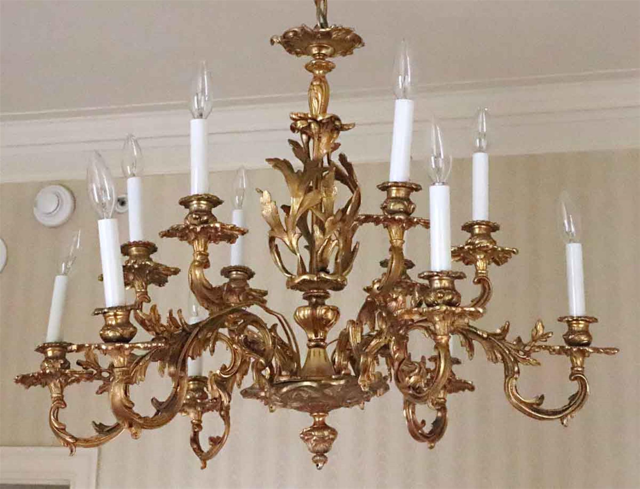 1980s NYC Waldorf Astoria Hotel organic gold gilt cast bronze filigree 12 arm chandelier from the Waldorf Astoria Towers. The gold gilt shows some wear, but adds to the charm of this historic chandelier. A Waldorf Astoria authenticity card included