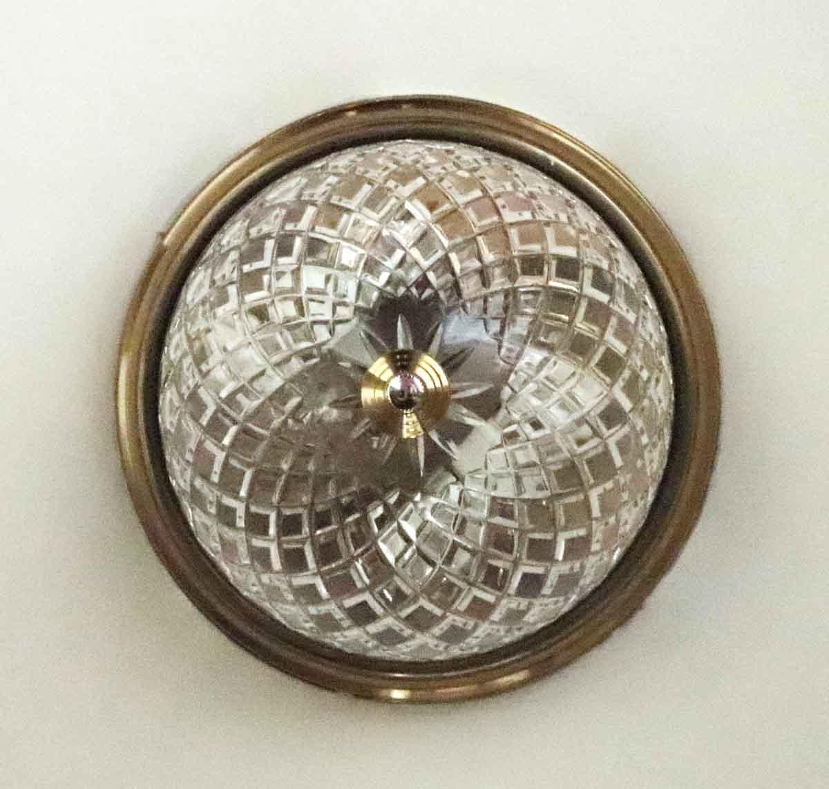 1980s cut crystal flush mount fixture with brass base. These are original to the suites and corridors of the NYC Waldorf Astoria Hotel Towers. Waldorf Astoria authenticity card included with your purchase. Priced each. Small quantity available at