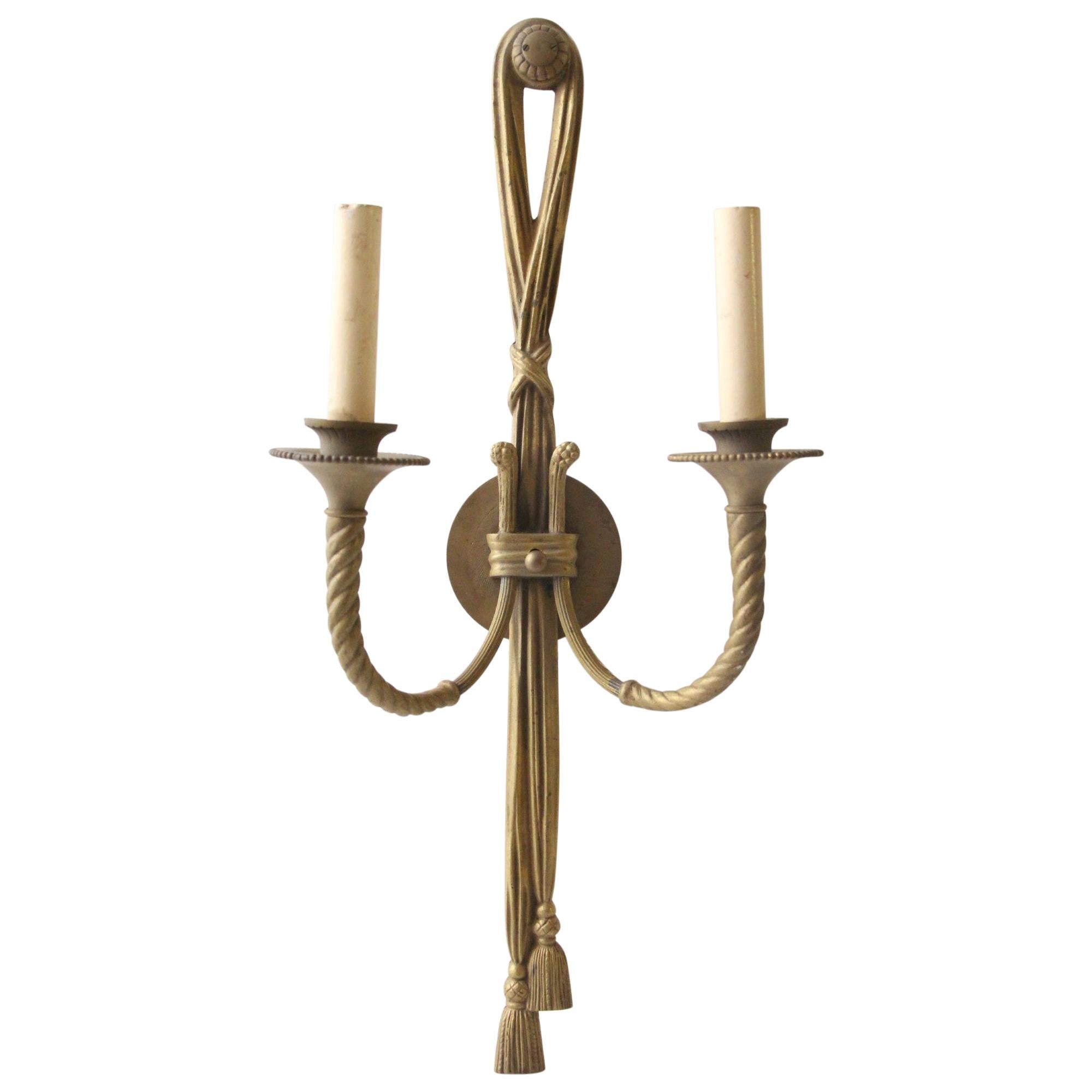 Tall and elegant neoclassical style rope twisted sconce with a brass construction and a tassel on the end. Price includes restoration. This can be seen at our 400 Gilligan St location in Scranton. PA.