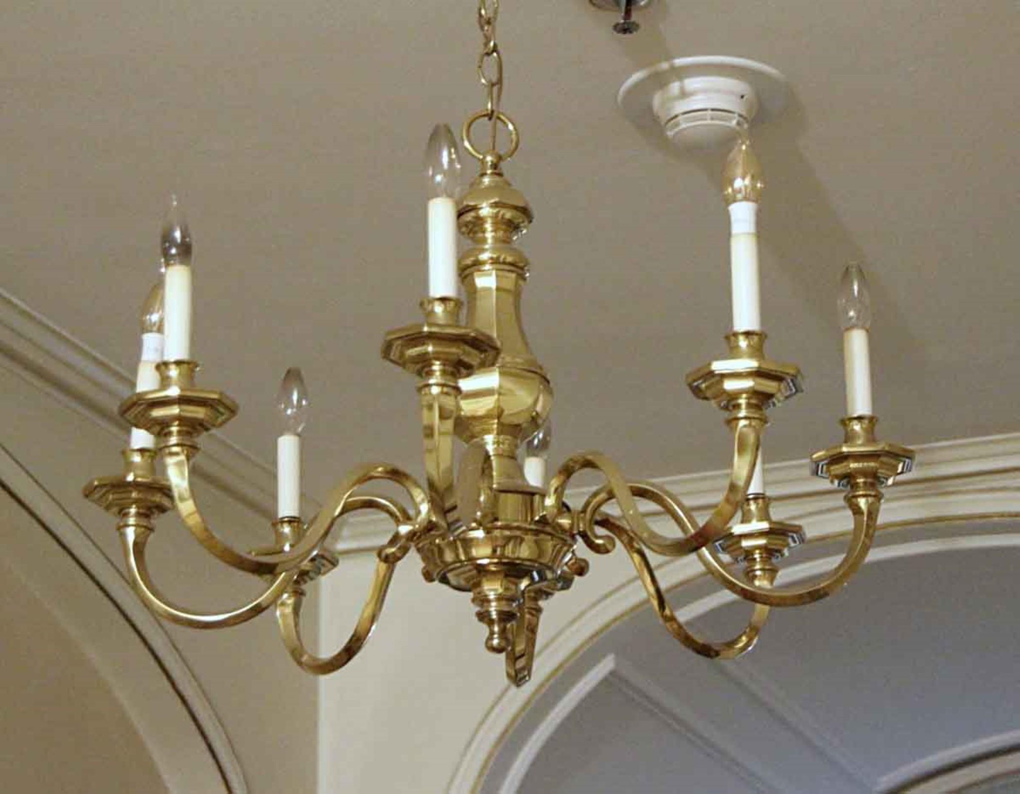 1980s brass chandelier done in a Williamsburg style. Features an octagon shaped body and matching bobeches. From the 41st floor suite A of the NYC Waldorf Astoria Hotel Towers on Park Ave. Waldorf Astoria authenticity card included with your