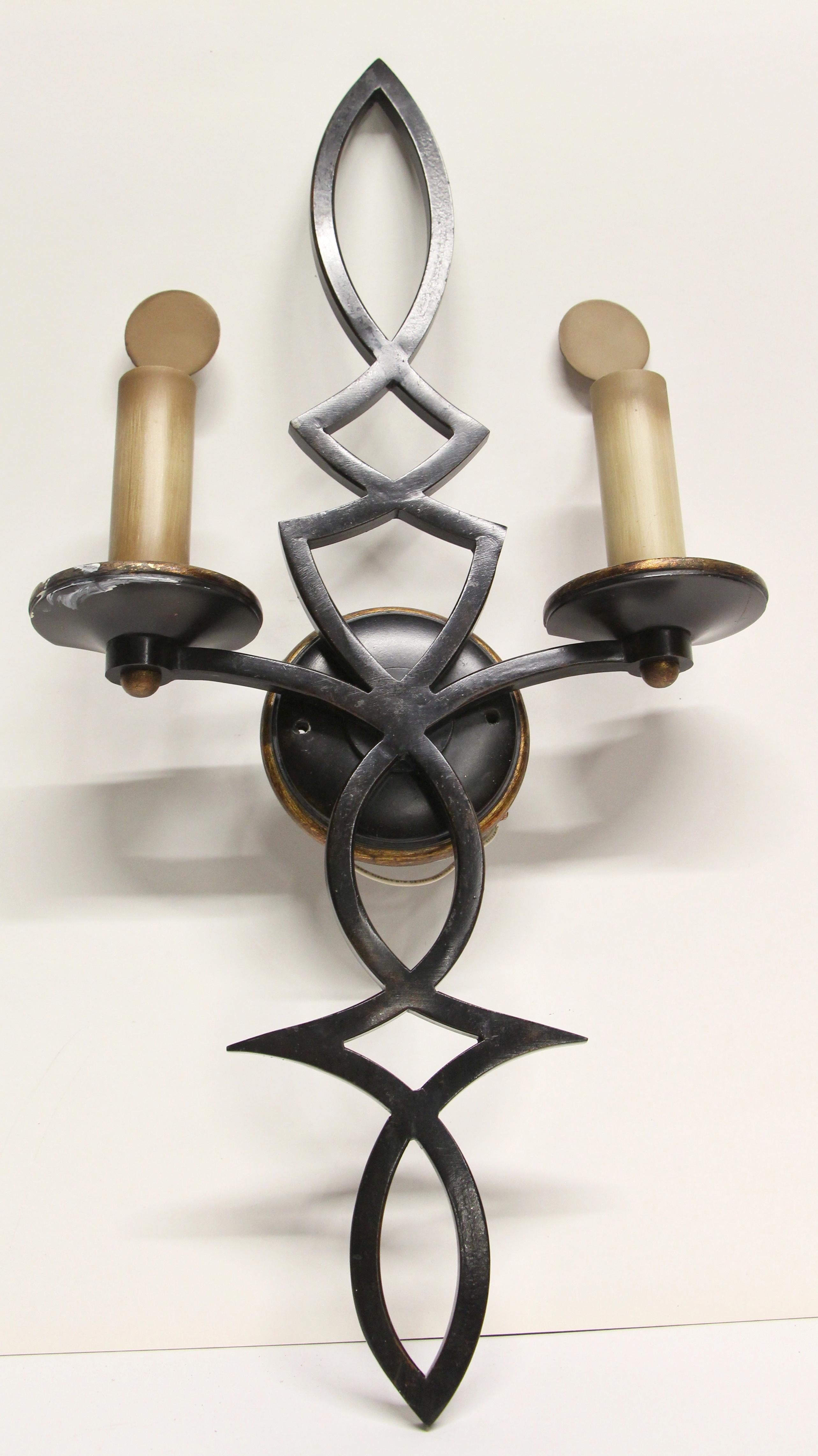 1980s NYC Waldorf Astoria Hotel wrought iron two-arm sconce with metal candlesticks and a black finish done in a Mid-Century Modern style. Priced each. A Waldorf Astoria authenticity card included with your purchase. Small quantity available at time