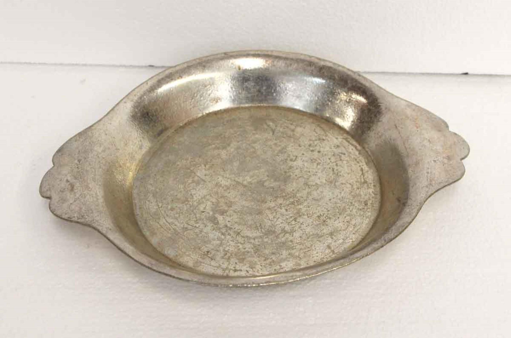 This shallow serving bowl is from the famed NYC Waldorf Astoria Hotel. It is silver plated brass and has scalloped handles for easy serving. It shows typical signs of wear and scratches for it's age. Included with your purchase is a Waldorf Astoria