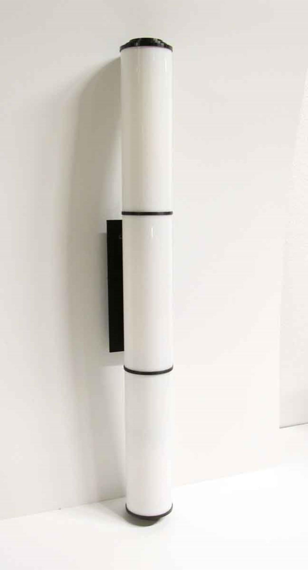 Mid-Century Modern white cylinder sconces from the 2008 opening of the Guerlain Spa. Also used in other Suites of The Waldorf Astoria Towers. Waldorf Astoria authenticity card included with your purchase. Not rewired. Small quantity available at