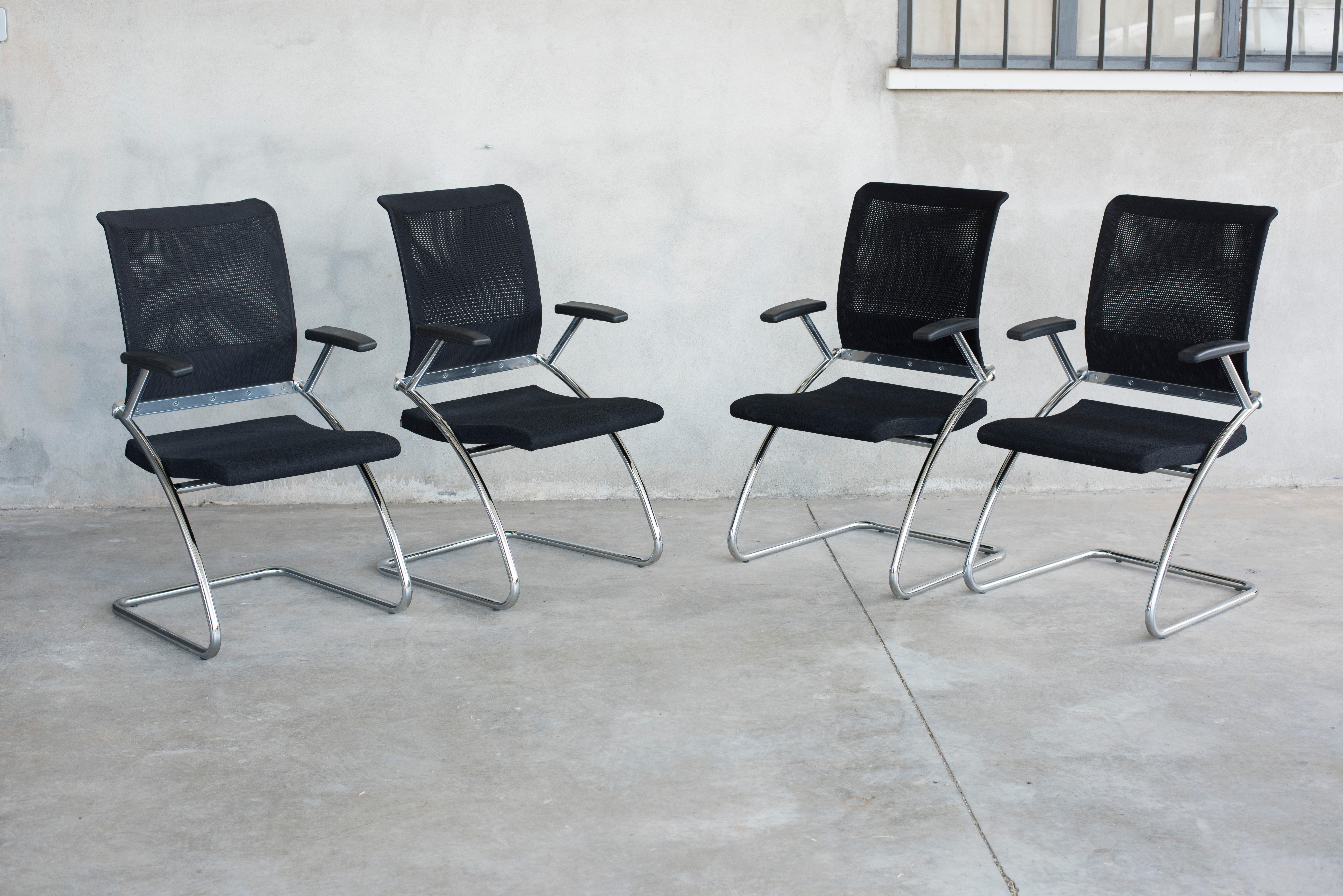 Ergonomic cantilever, eight chairs available. 
Black technical upholstery, chromed steel structure and armrests.
Very comfortable and welcoming with their large and deep seats and high backrest.
From Italy from 1980s production.
Size: w 52 cm x