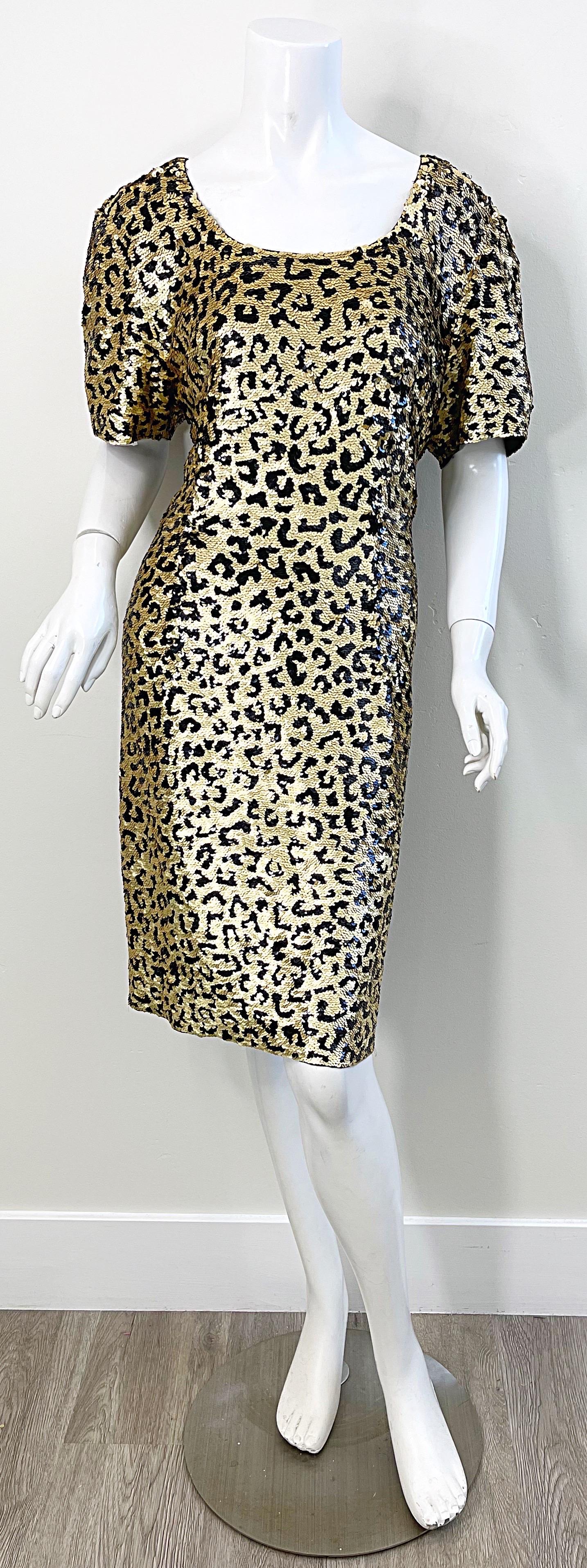 Fabulous 1980s vintage OLEG CASSINI fully sequined leopard print short sleeve silk dress ! Features thousands of hand-sewn gold and black sequins throughout the entire dress. Hidden zipper up the back with hook-and-eye closure.
Great belted or