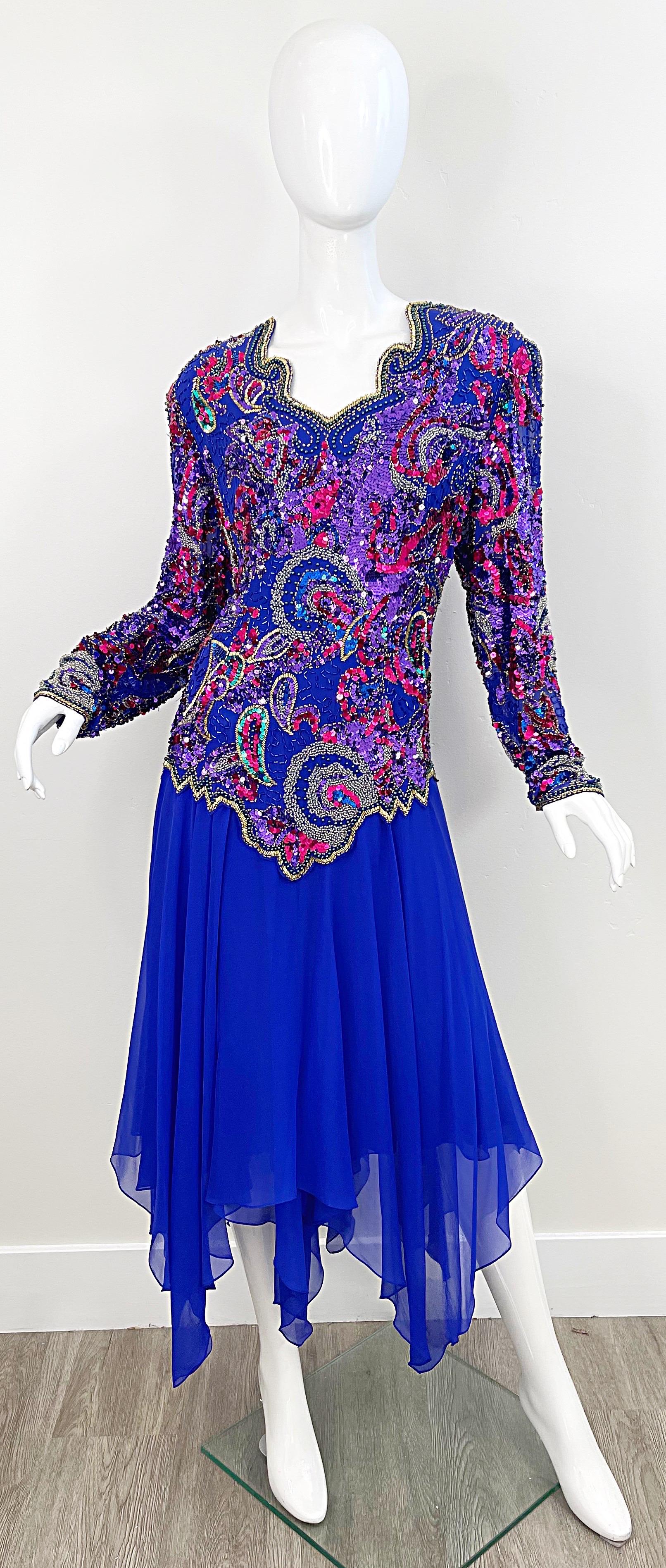 Beautiful vintage 80s OLEG CASSINI purple beaded silk chiffon drop waist handkerchief hem sequins dress ! Features thousands of hand-sewn sequins and beads in pink, purple, blue and silver. Flattering unusual v-neck. Hidden zipper up the back with