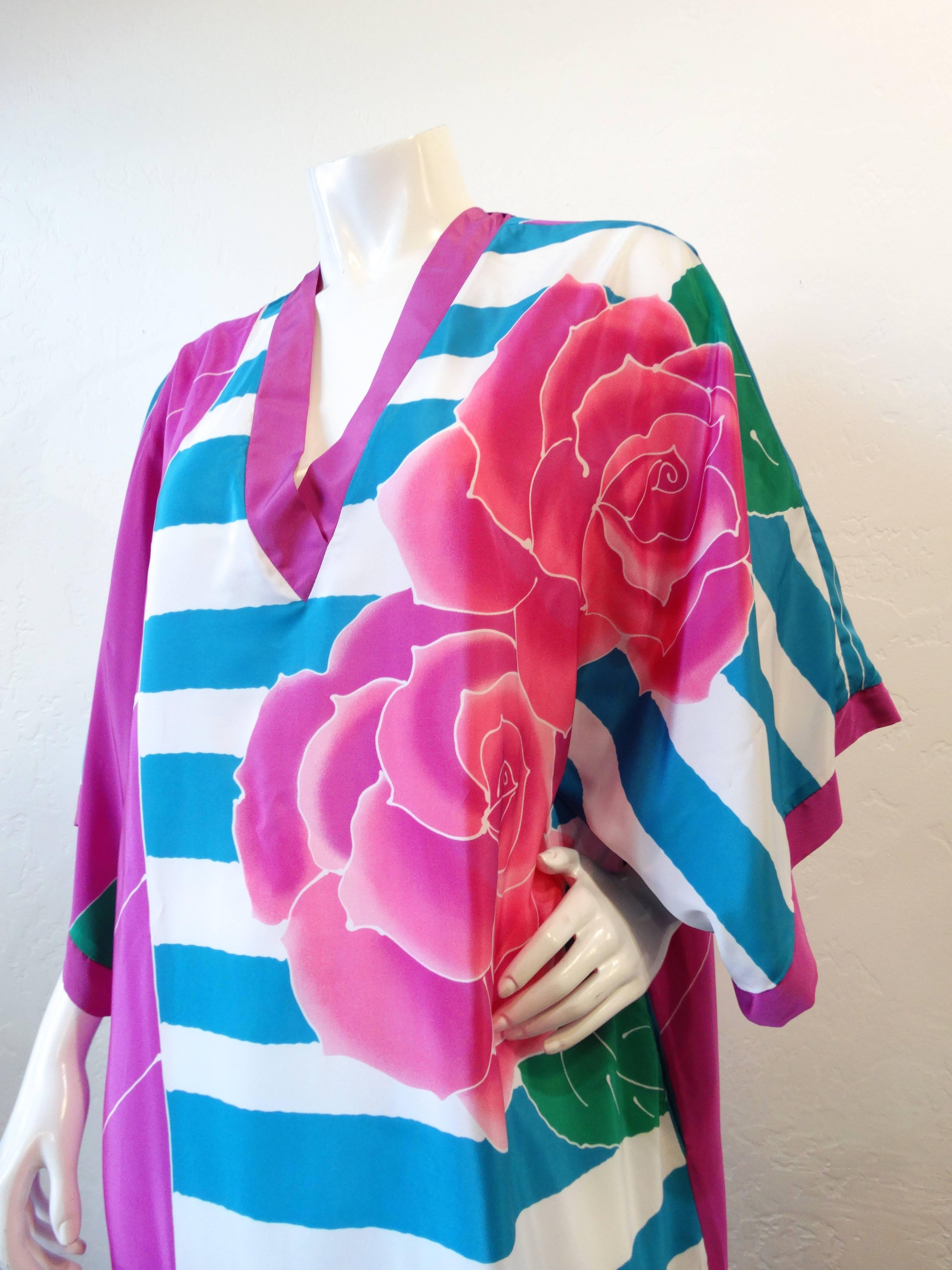 This Oscar De La Renta dress from the 1980s is just what your cruise wardrobe needed! Made of a soft silky fabric, printed with bold graphic blue and white stripes with contrasting pink roses down the left side. Flattering v neck with flowy, kimono