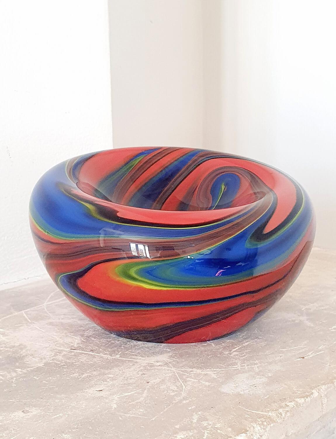 In the 1980s Ottavio Missoni designed a small collection of Murano glass pieces with the Venetian furnace, Vetri Arte Murano. This wonderful large glass red bowl is one of the most exceptional pieces from the collection both in terms of form and