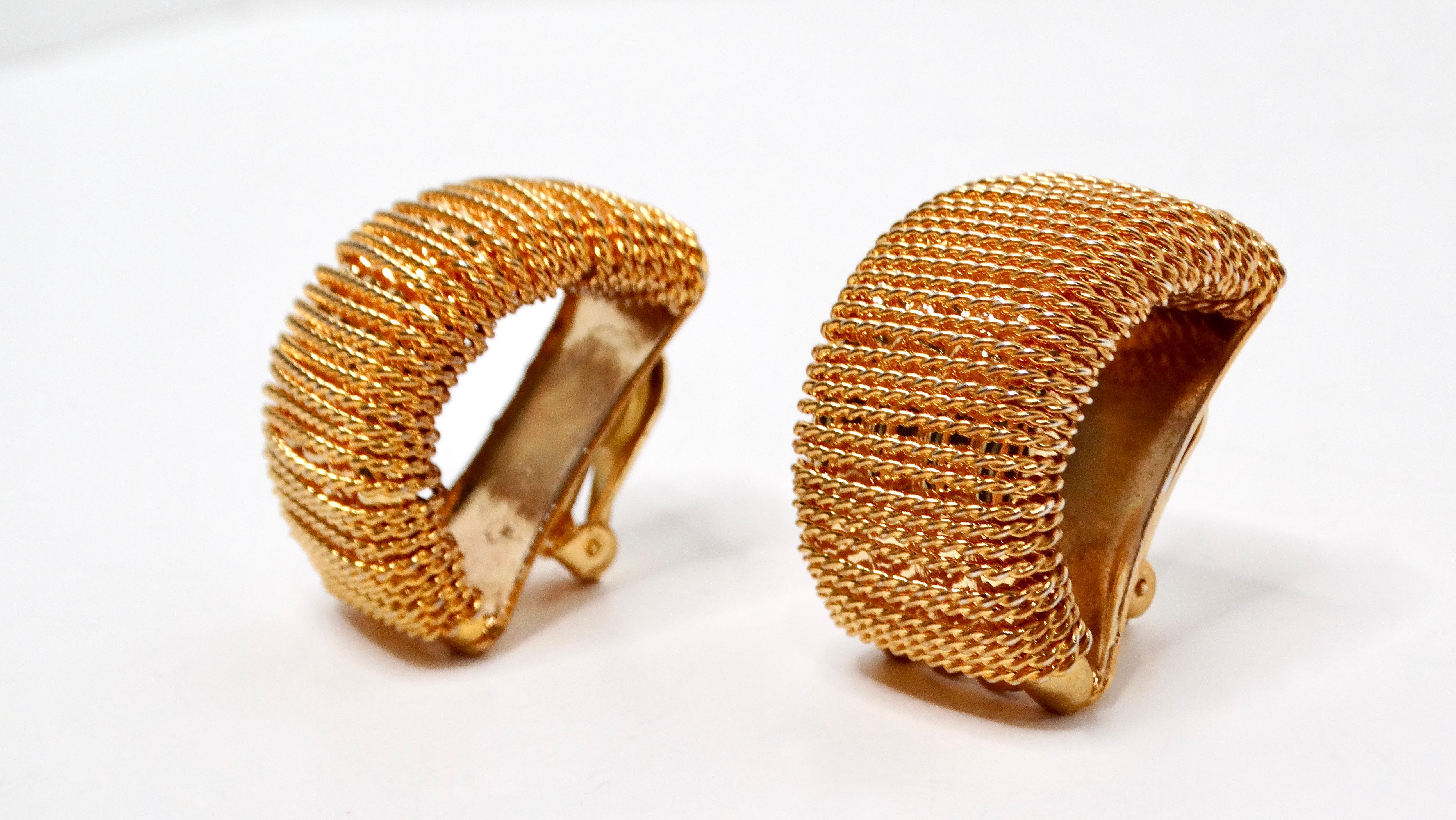 Introducing a stunning pair of 1980s oversized 18k gold-plated rope chain statement clip-on earrings, a perfect embodiment of bold vintage chic. These earrings capture the essence of the glamorous '80s with their dramatic size and eye-catching