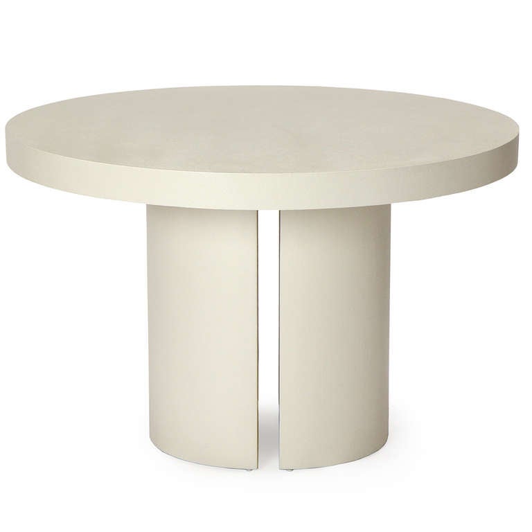 A unique circular pedestal table with a split leg design, all tightly covered in a painted canvas.
