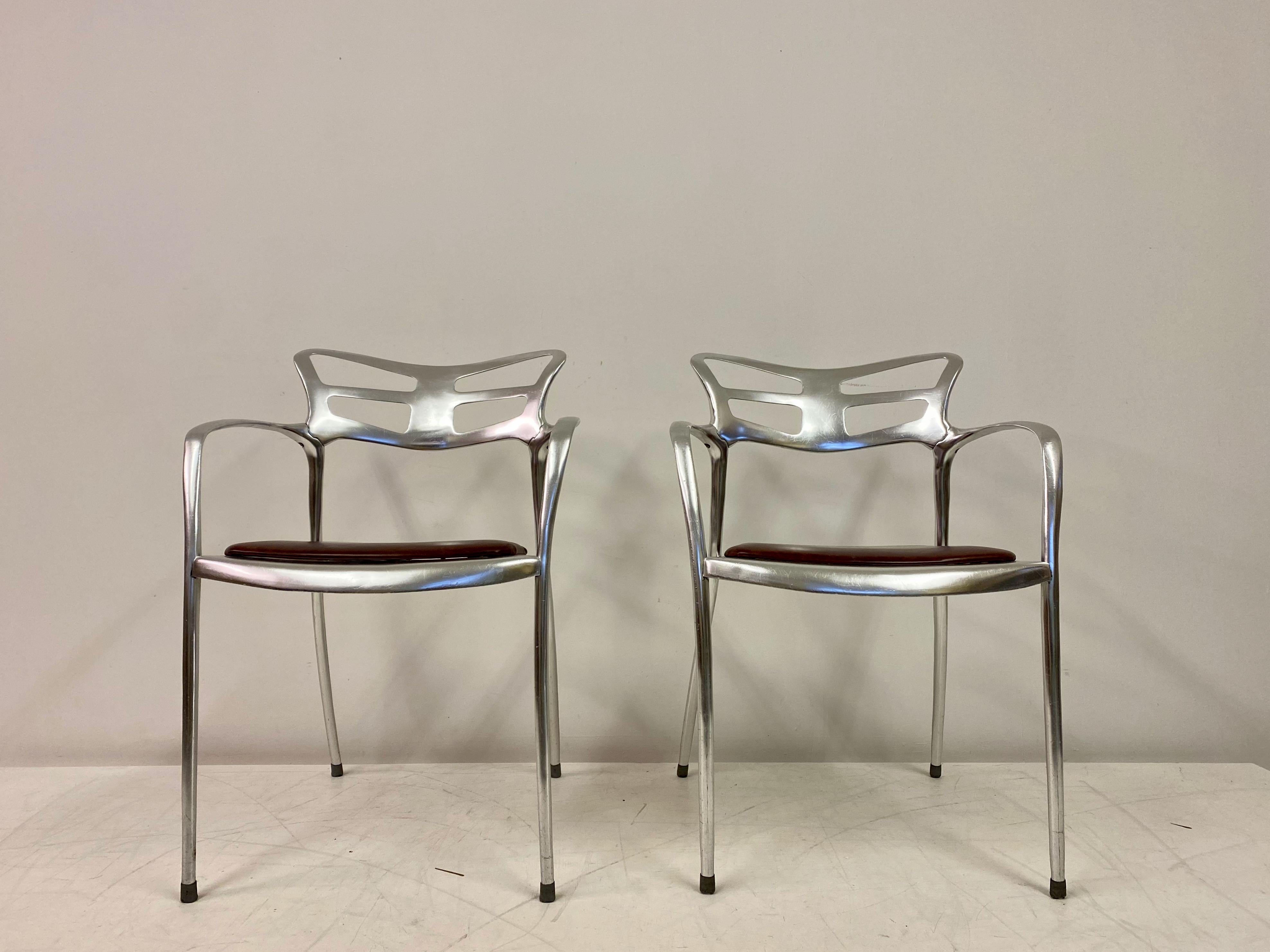 Pair of armchairs

Cast aluminium frames 

Leather seats

Similar to Jorge Pensi's Toledo chairs

Seat height 47cm

1980s.