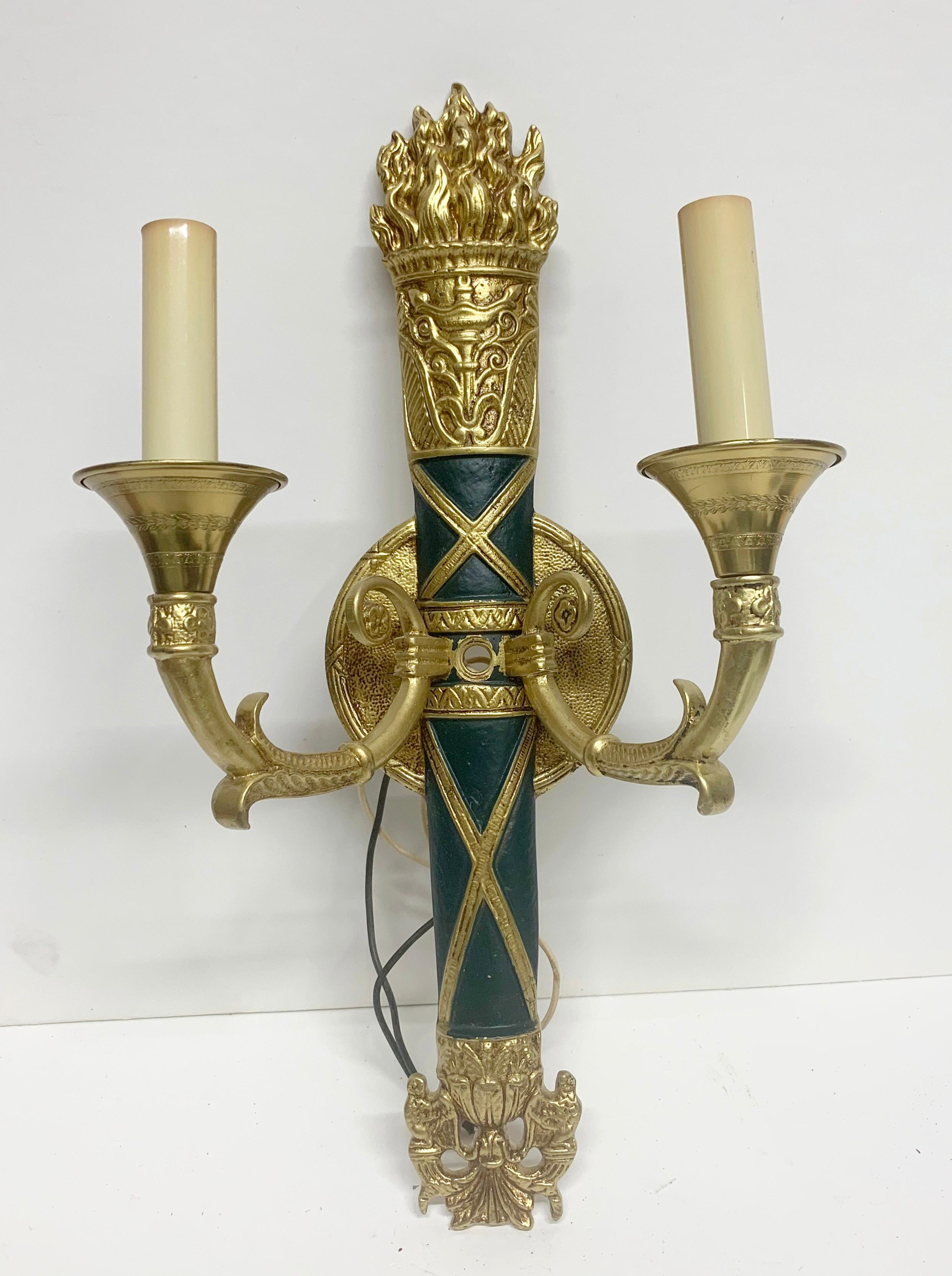 1980s cast brass two-arm sconces with emerald green and gold painted details. From the NYC Waldorf Astoria Hotel. Priced as a pair. Price includes wiring and cleaning. Please allow 1-2 weeks to process. A Waldorf Astoria authenticity card included