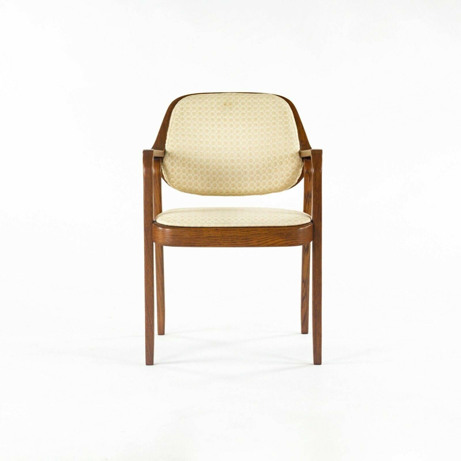 Listed for sale is a pair of iconic No. 1105 chairs, designed by Don Petitt for Knoll. This is a notable pair that came from the home of a Knoll employee, who worked at the company for over 50 years. The chairs were both specified in a dark oak