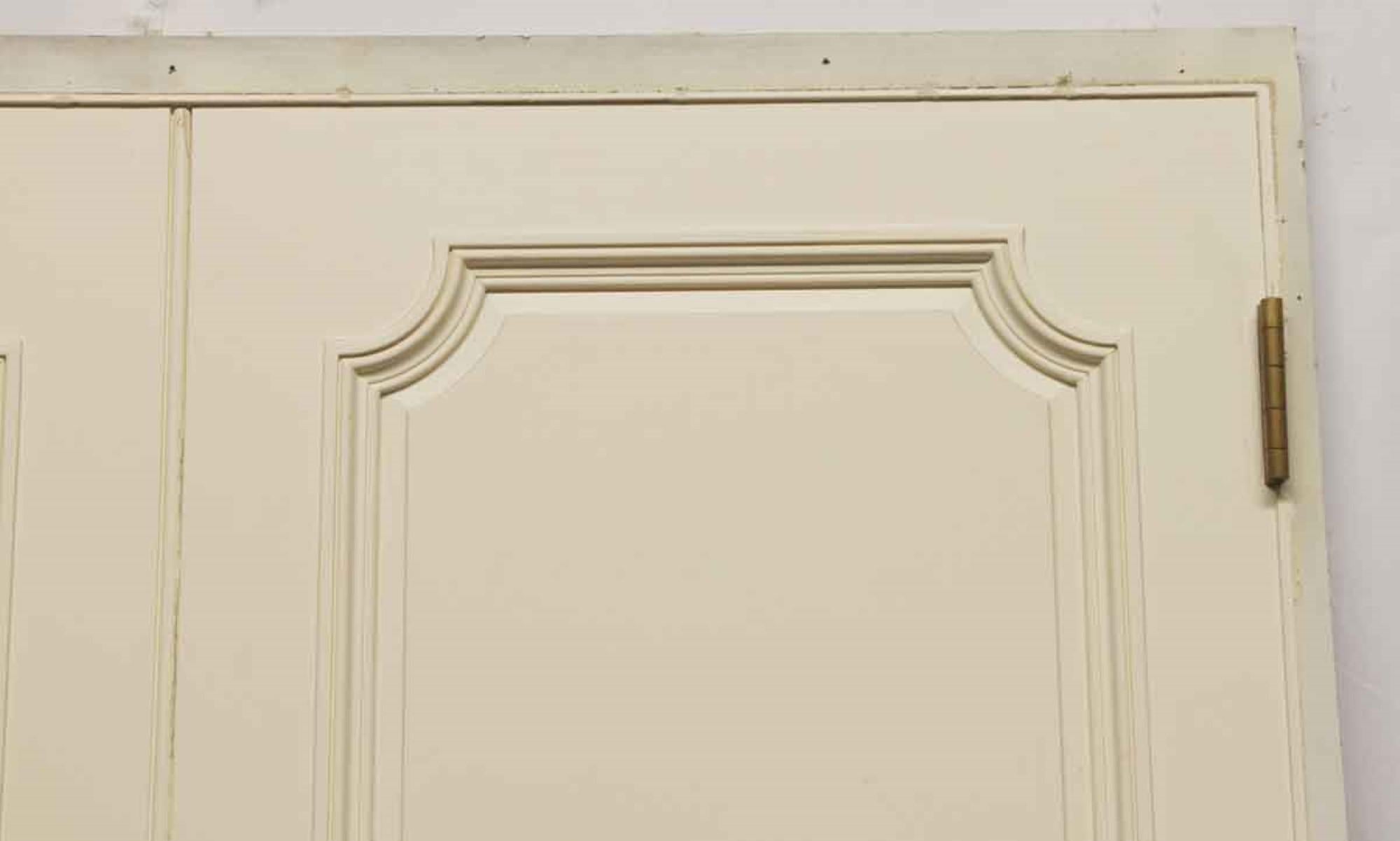 Single 1980s white painted wood faux double door panel with French door hardware. When installed this gives the illusion of a pair of doors where none exist. Retrieved from a New York City Apartment on 5th Ave. This can be seen at our 400 Gilligan