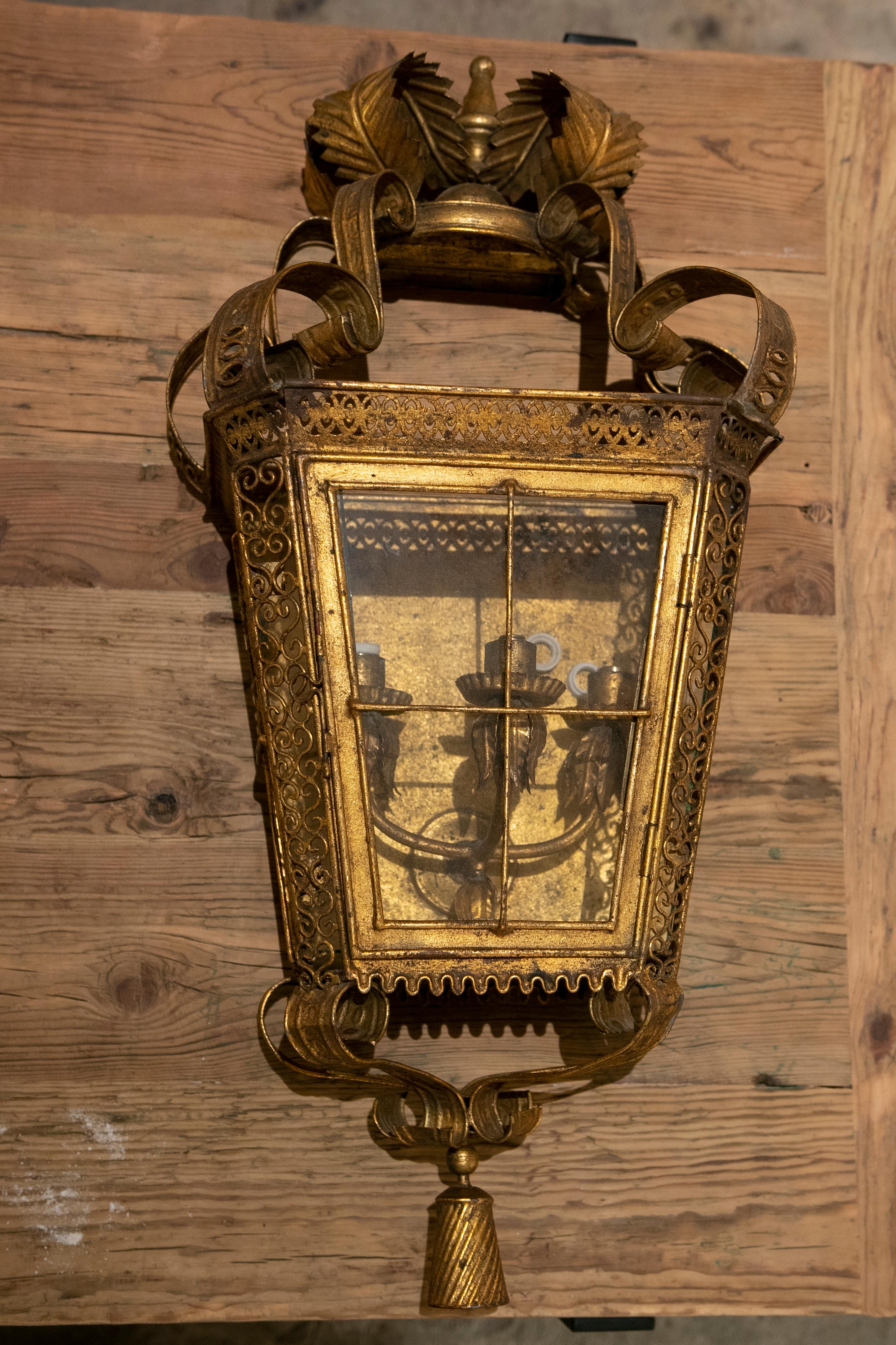 1980s Pair of gilded iron wall lanterns with glasses.