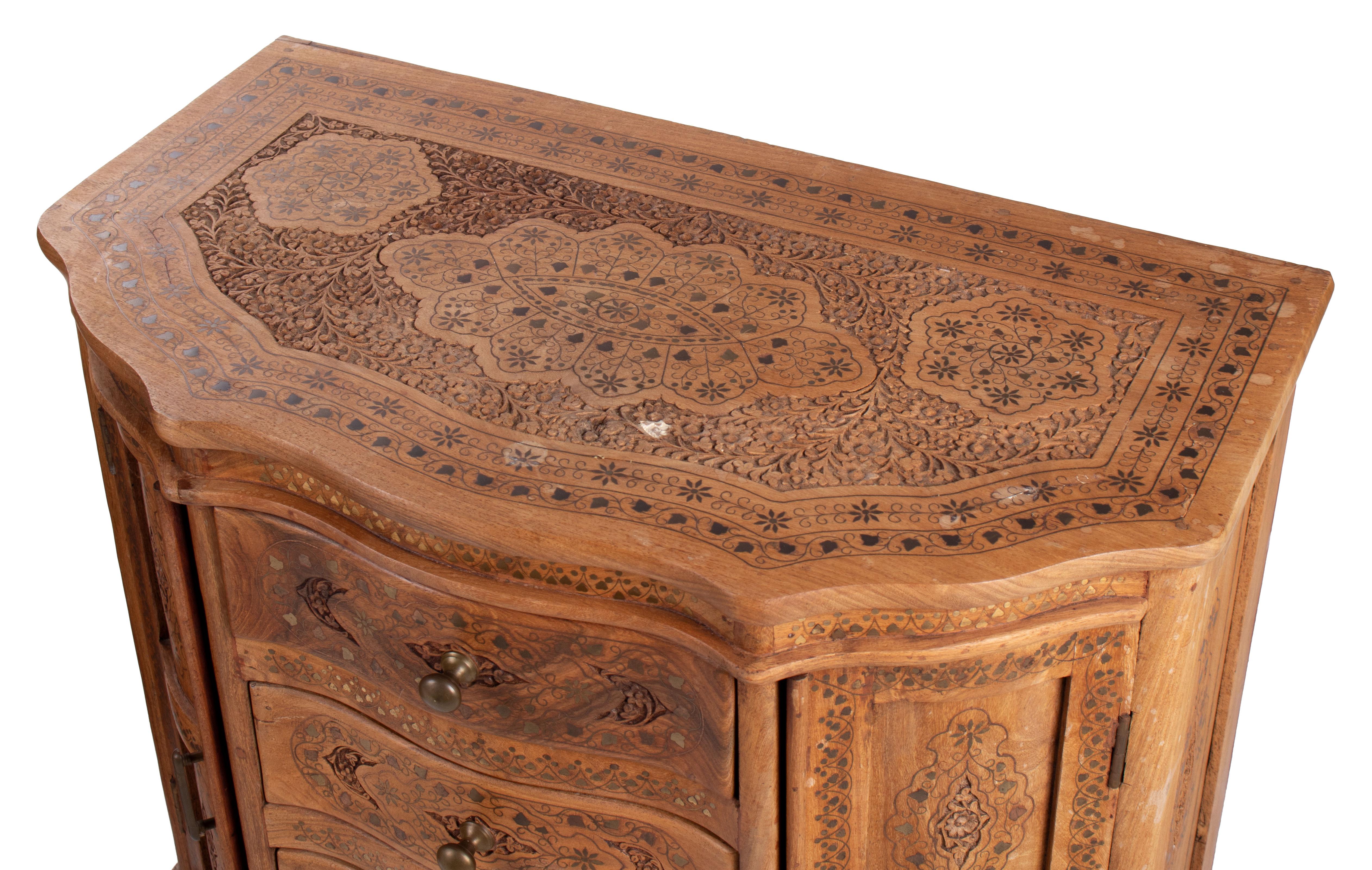 1980s pair of hand carved four-drawer chest with panel doors and brass fittings.