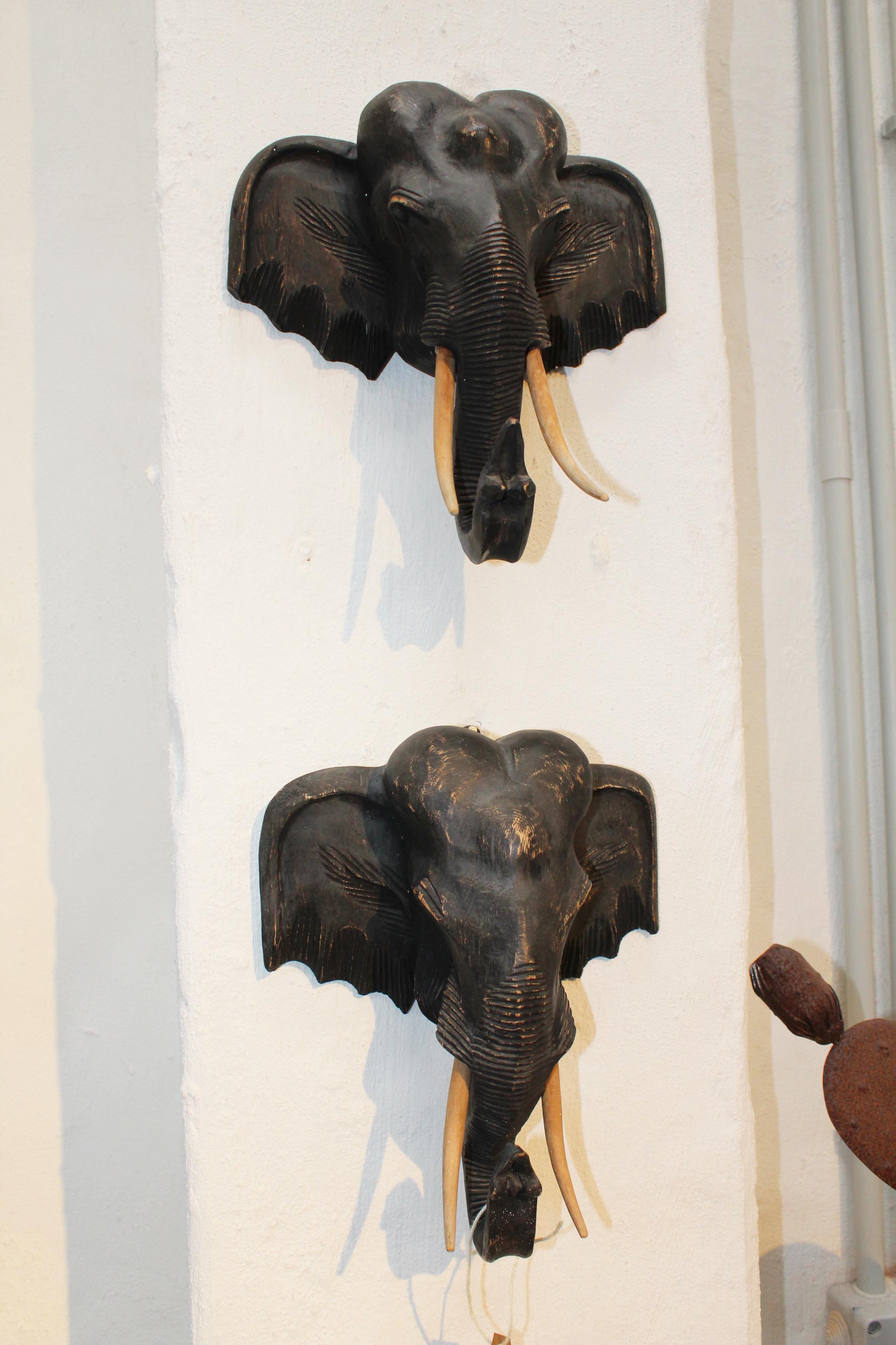 1980s pair of hand carved wooden elephant heads.