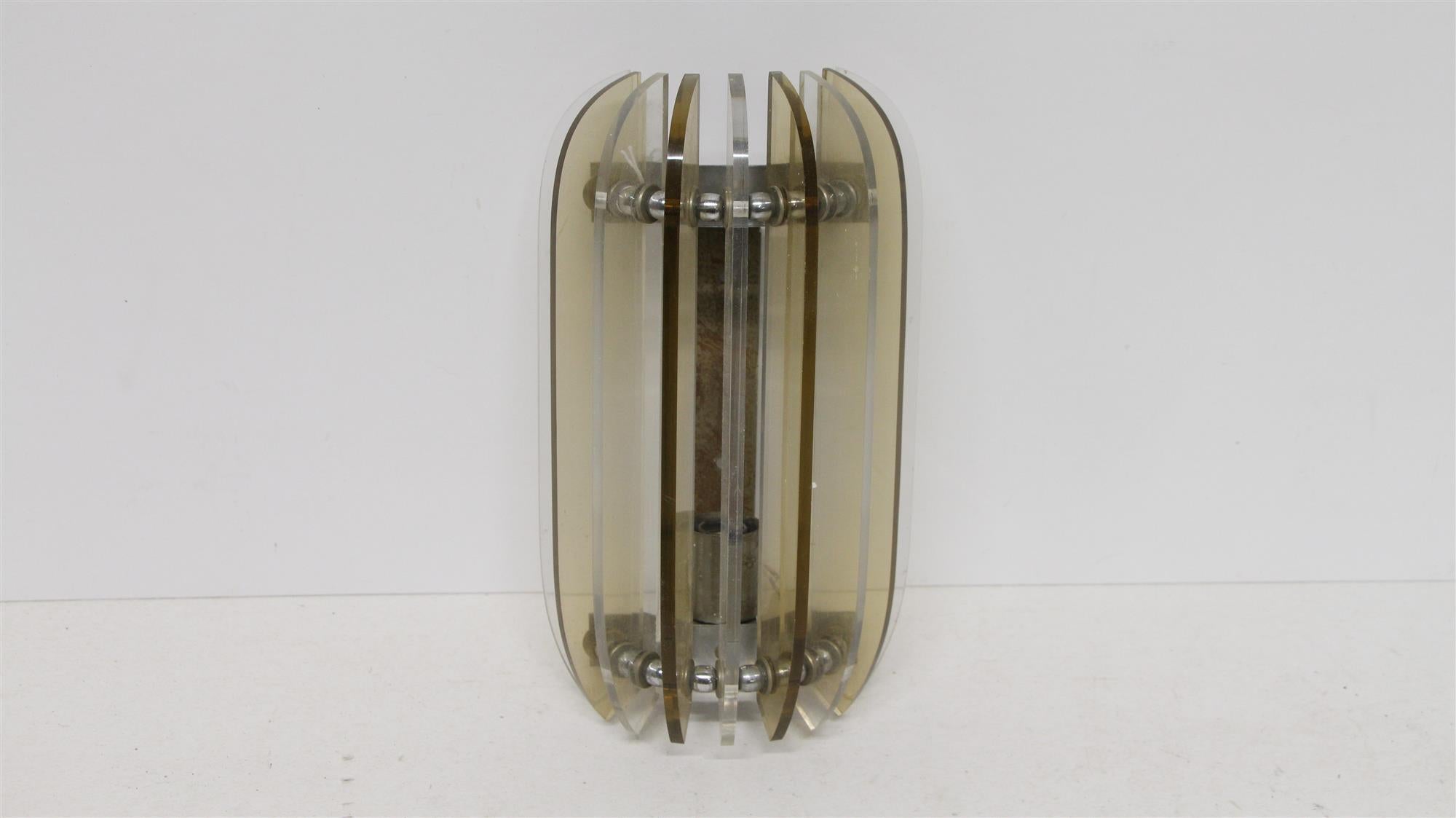 1980s Mid-Century Modern Italian Lucite wall sconces with a metal frame. Priced as a pair. This can be seen at our 71 8th Ave location near the Meatpacking District in Manhattan.
