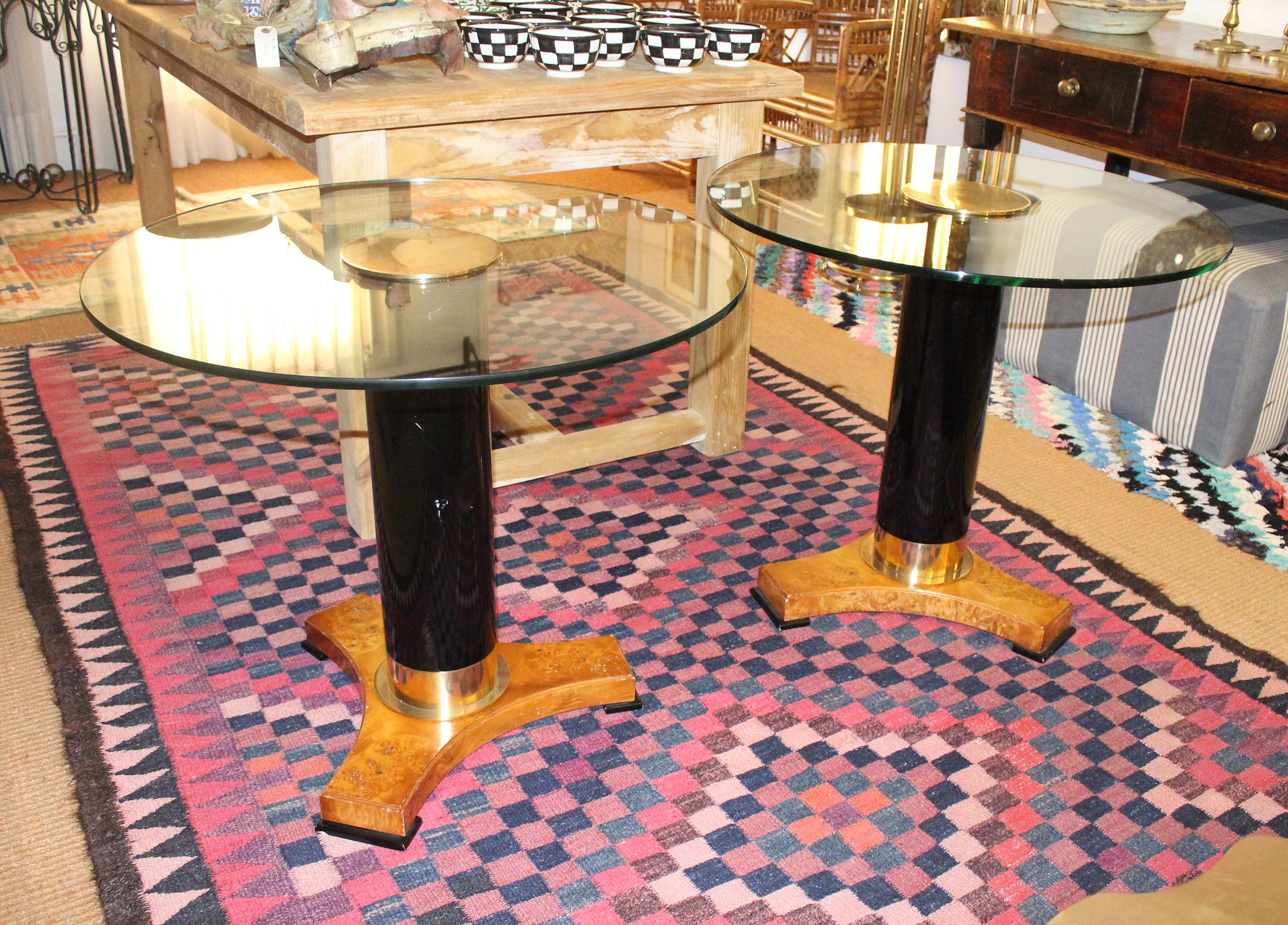 1980s elegant pair of Italian round glass top tables with a brass decorated wooden pedestal and wood root base

