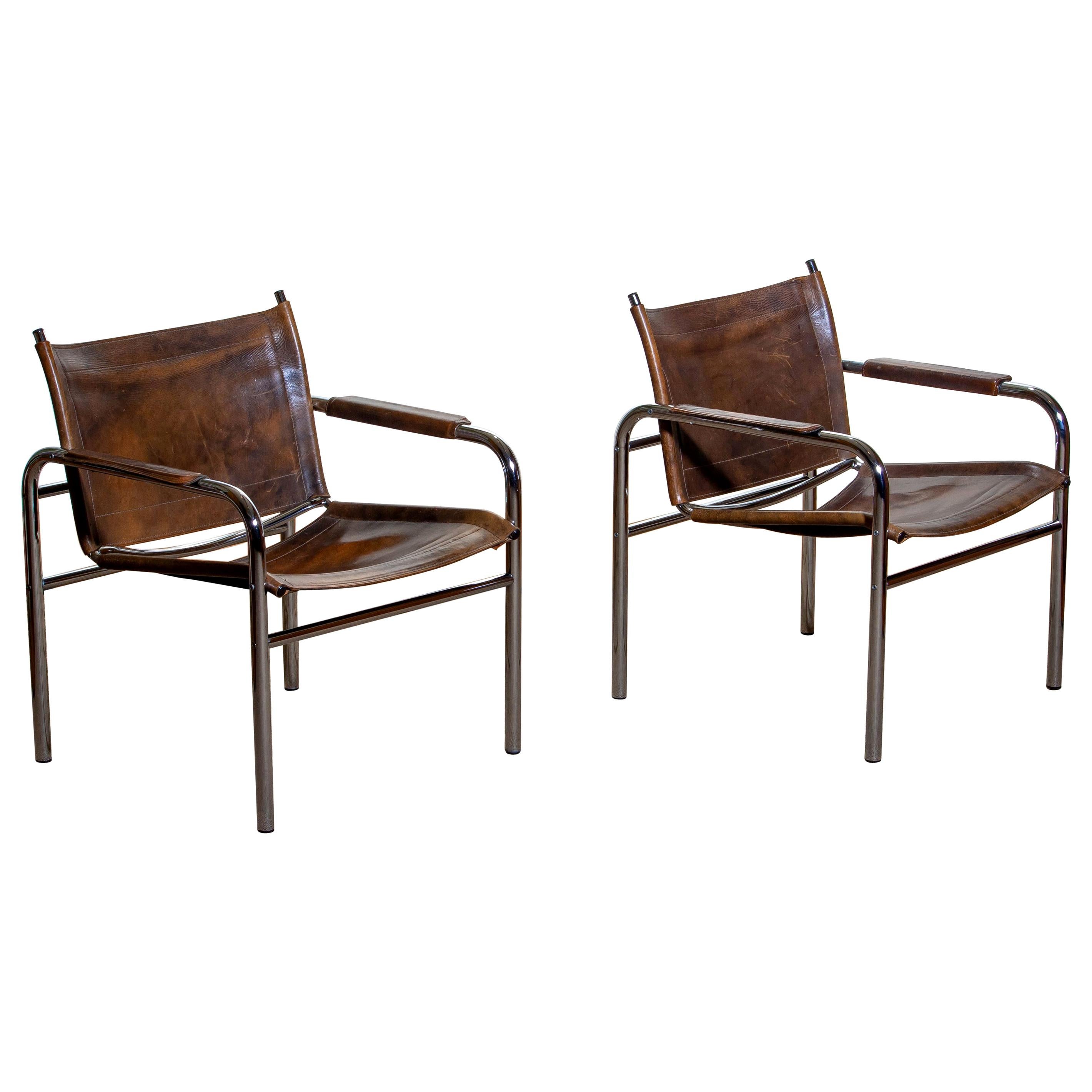 Beautiful pair of armchairs, model Klinte, designed by Tord Bjorklund, Sweden. The chairs having a tubular chromed steel frame with brown-taupe leather back / seating and armrest with a beautiful patina.
Period: 1980.
 