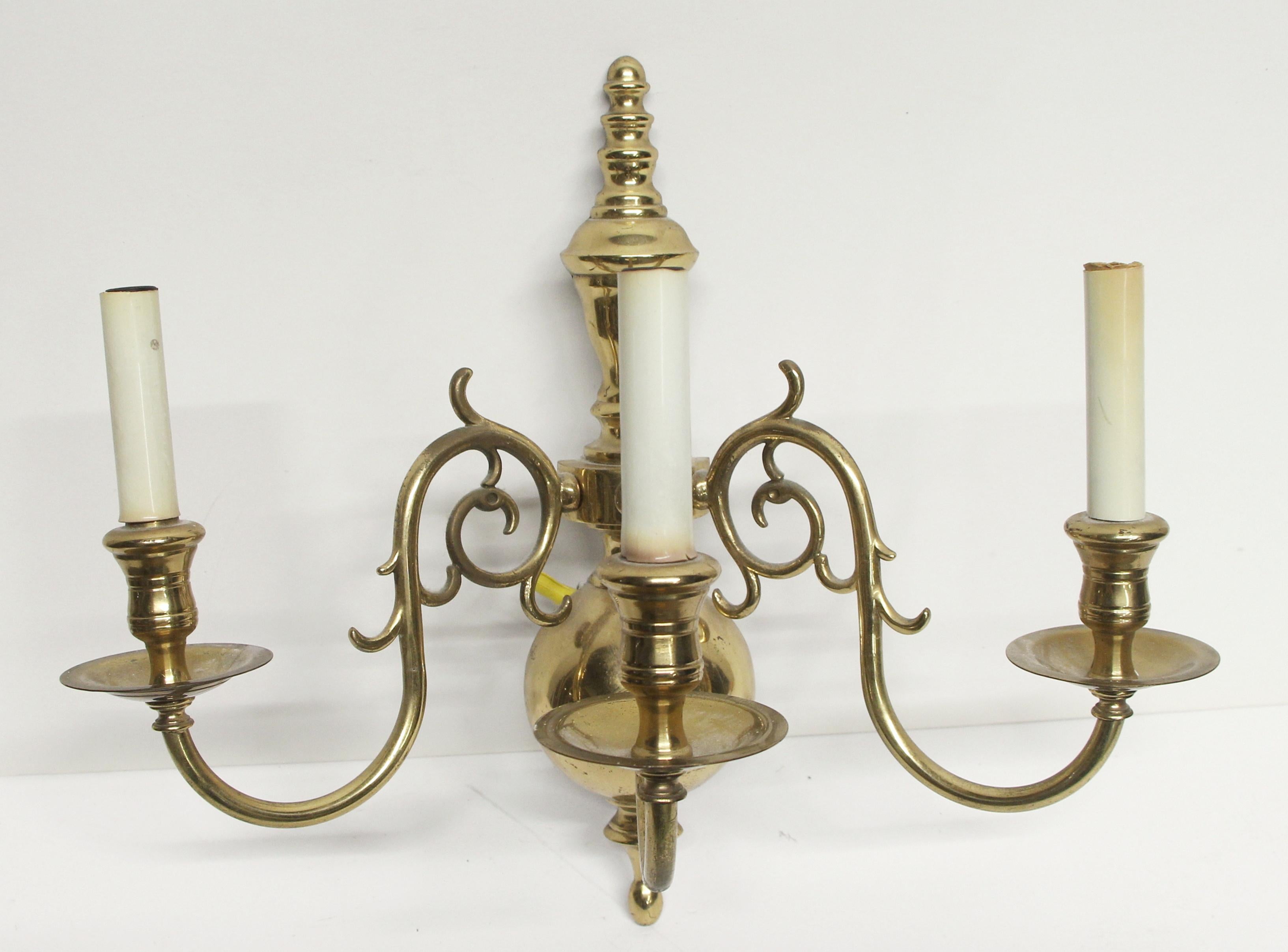 From the 1980s, NYC Waldorf Astoria Hotel. Three candlestick arm brass colonial style scones with a polished finish. Priced as pair. A Waldorf Astoria authenticity card included with your purchase. This can be seen at our 400 Gilligan St location in