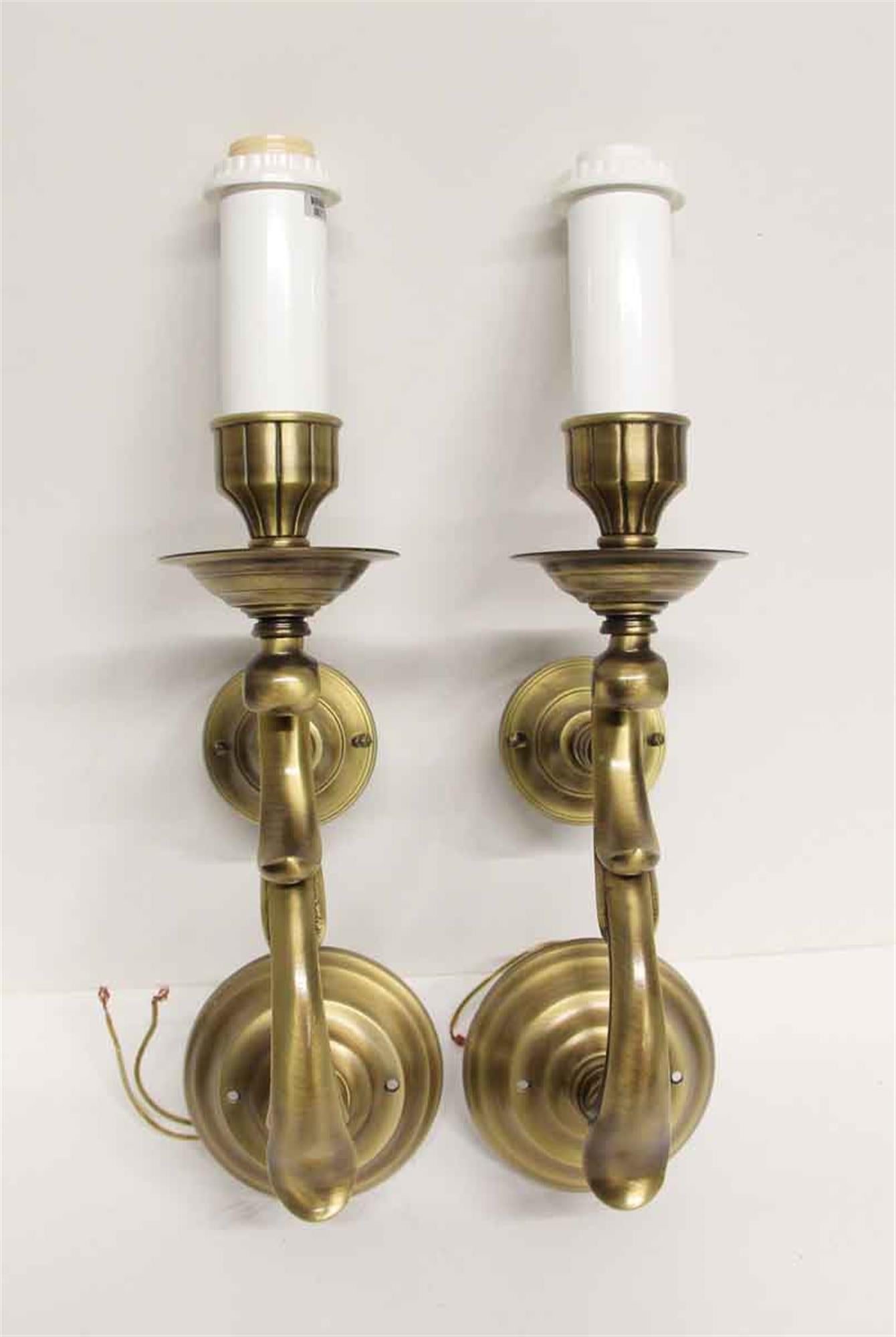 1980s pair of single arm brass sconces with an antique patina and black shades from the NYC Waldorf Astoria Hotel. A Waldorf Astoria authenticity card included with your purchase. This can be seen at our 400 Gilligan St location in Scranton, PA.