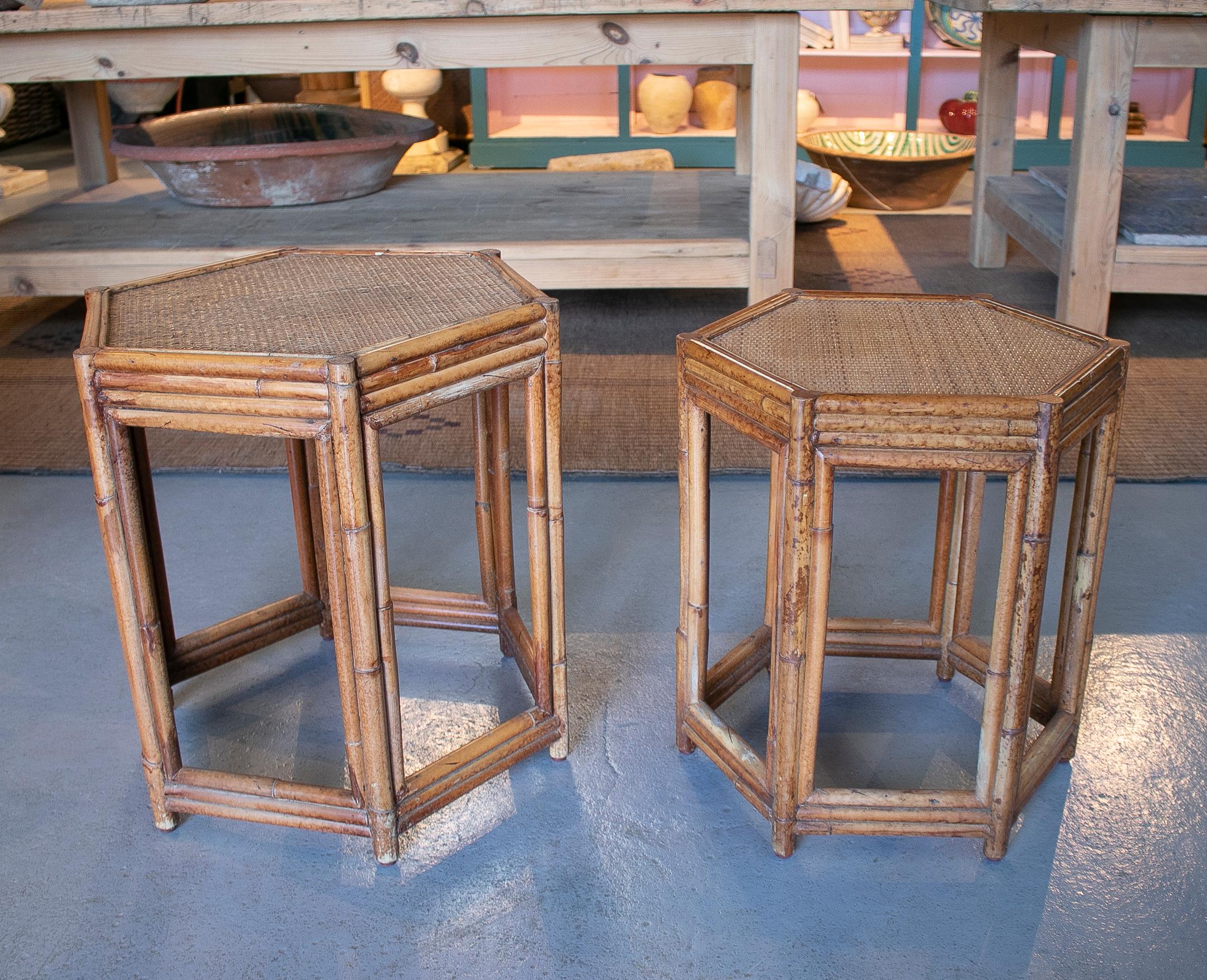 1980s pair of Philippine octagonal bamboo and rattan small tambles. 

Dimensions 56 x 48cm and the smaller 51 x 41cm.