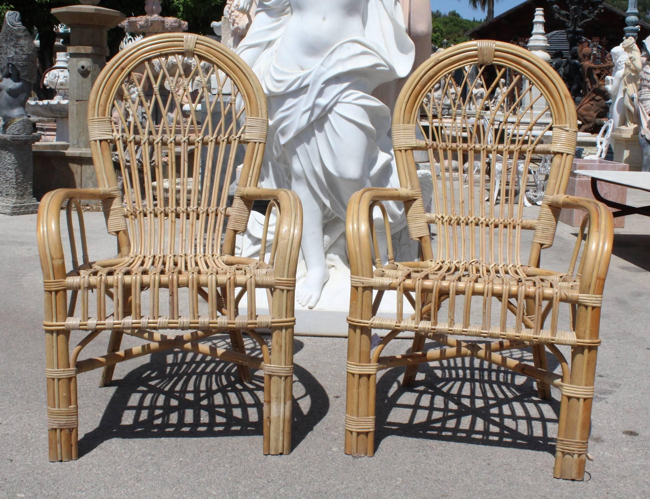 1980s pair of Spanish bamboo armchairs with rounded back rest.