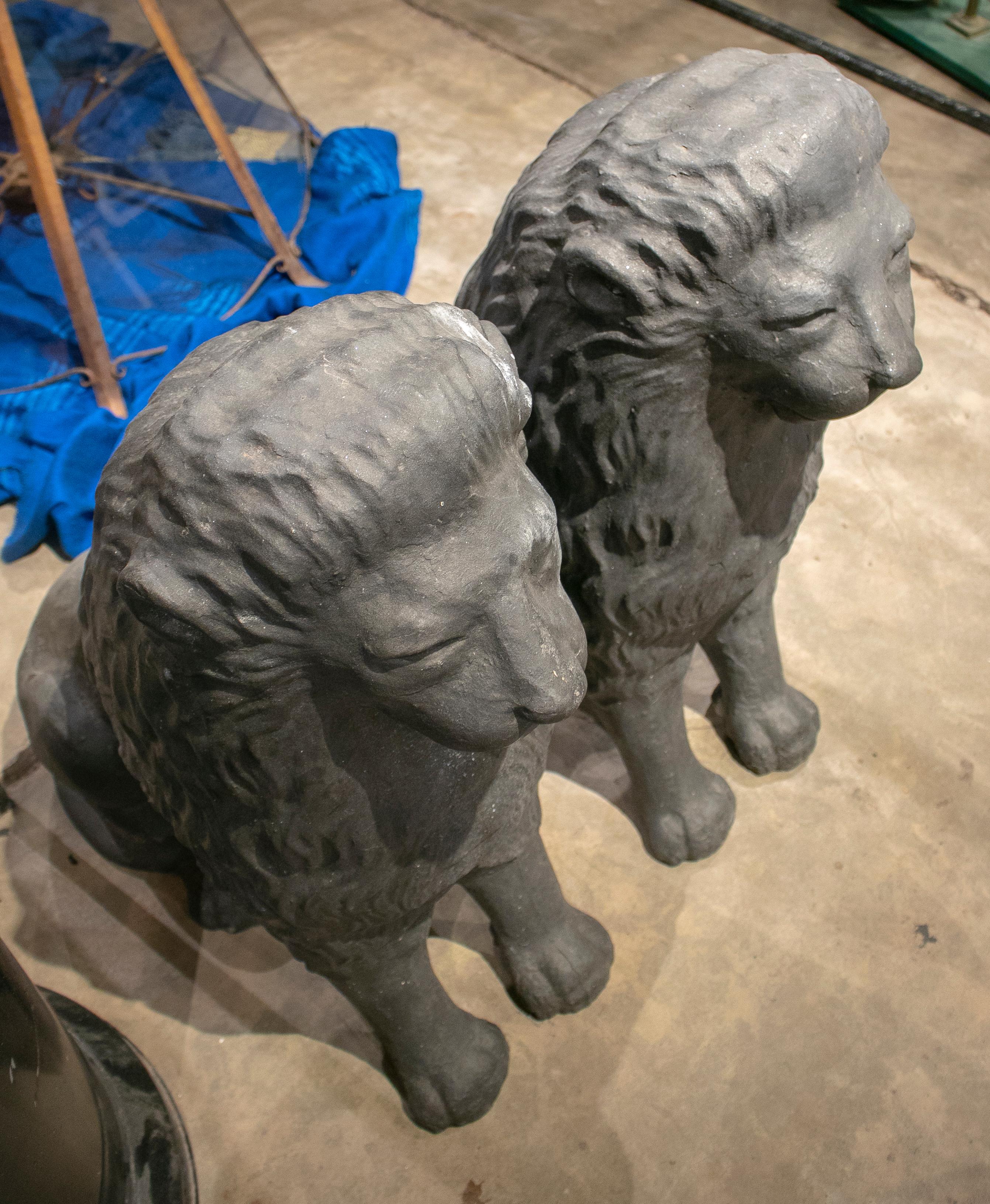 1980s pair of Spanish cast iron sitting lions.