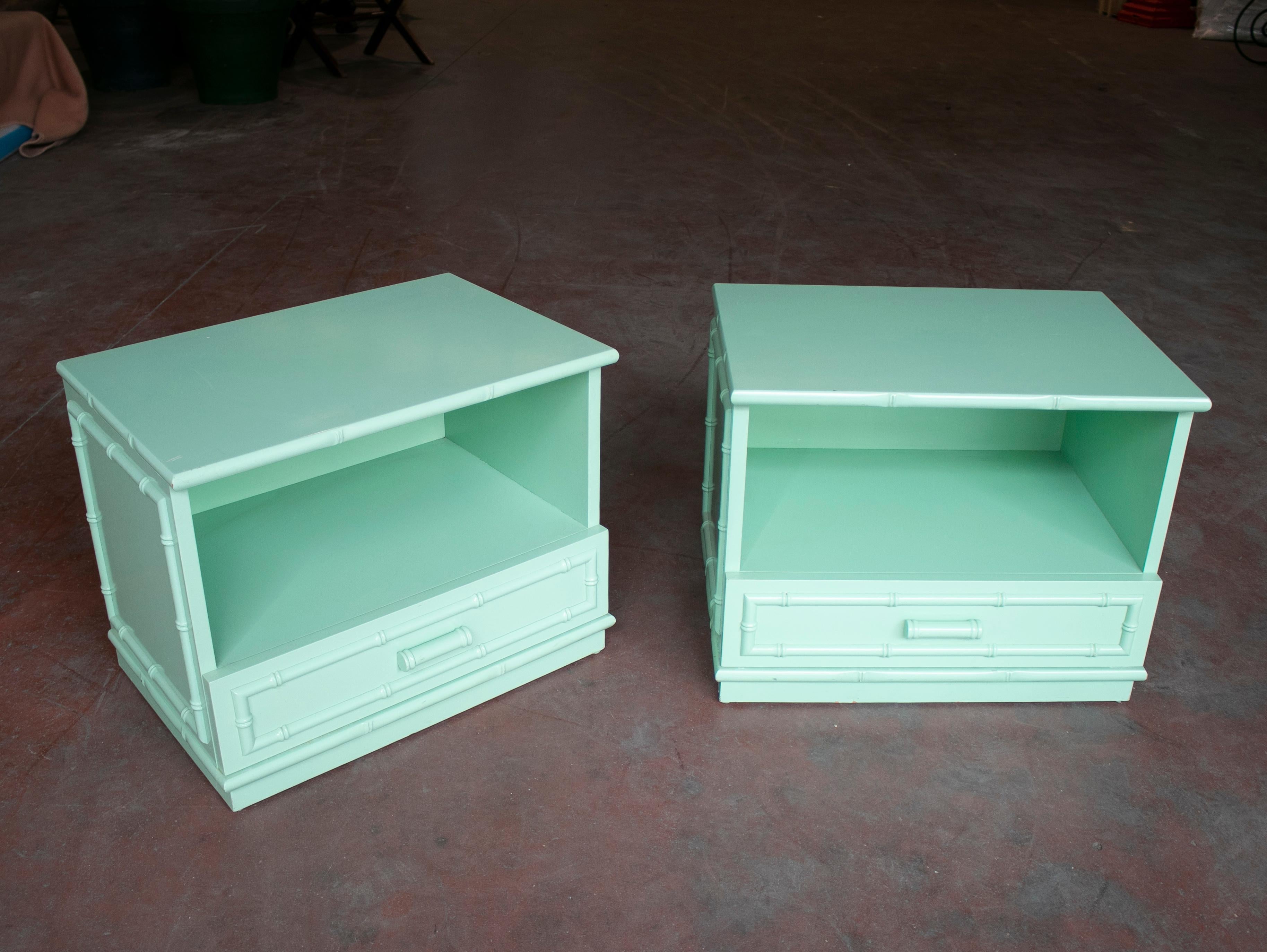 1980s pair of Spanish one drawer wooden bedside tables with bamboo style decoration, painted in green.
