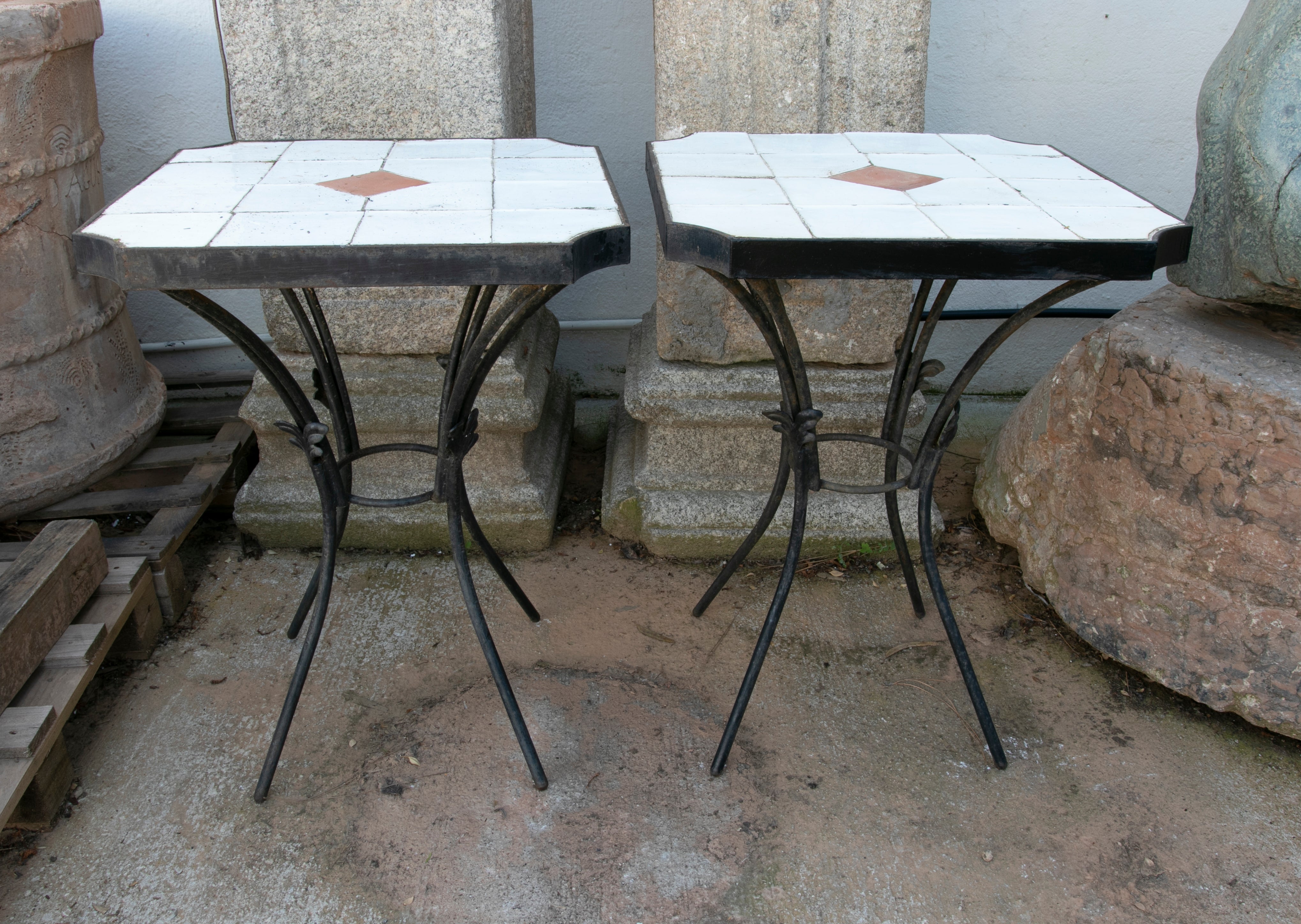 1980s Pair of tables with iron base and geometrical tiles on top.