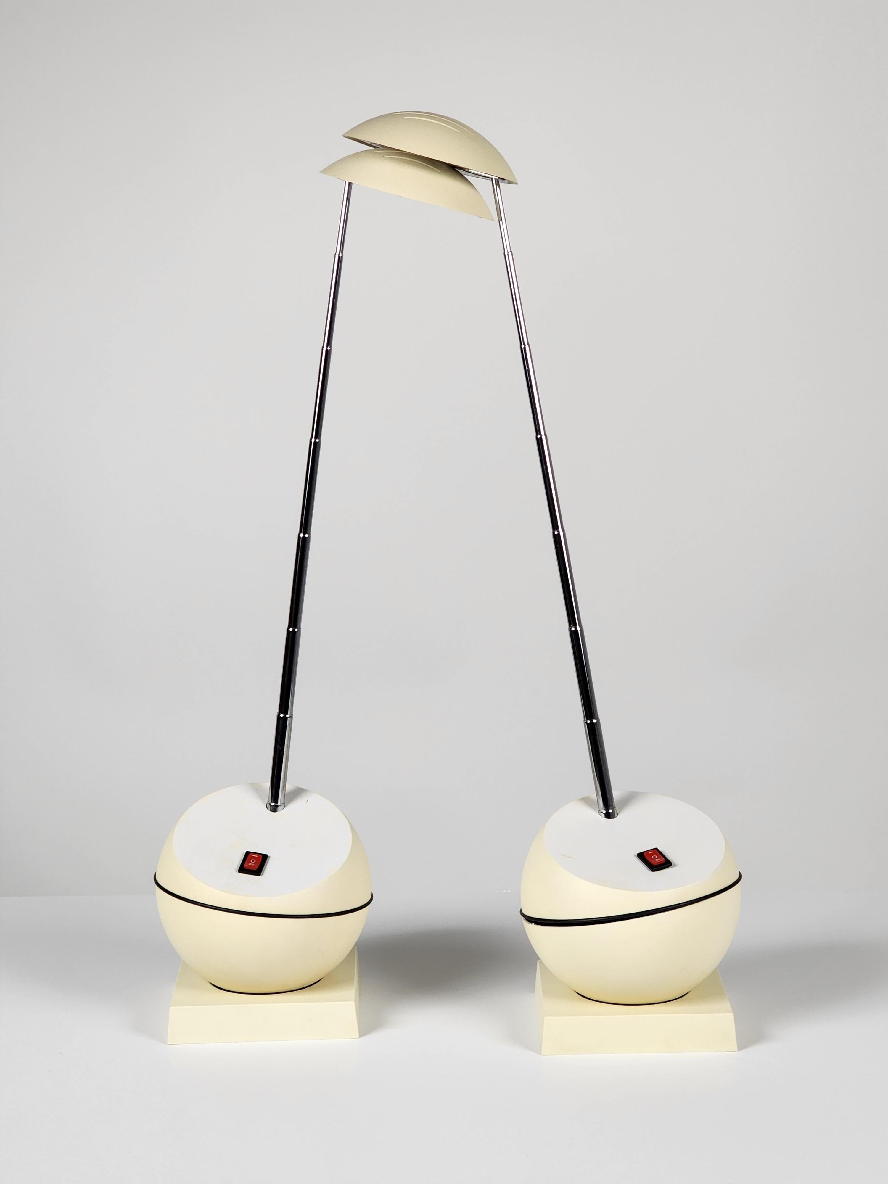 Pair of playfull and versatile Italian telescopic halogen table lamp . 

Rotate in any direction on base . 

Car antena fully enclose in base . 23 inches fully extended . 

Shade flap up and down and rotate a full 360 degree. 

Use 2 pin 35
