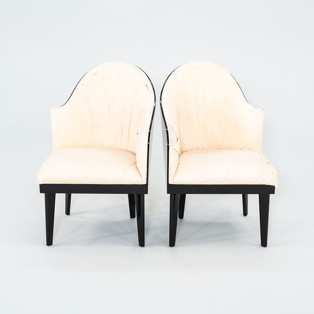 This is pair of Toscana chairs, designed by Piero Sartogo and Nathalie Grenon for Saporiti Italia in 1986. Their design features a sculptural, curved back with burled Birdseye maple veneer, and has thick black lacquered trim. When pushed together,